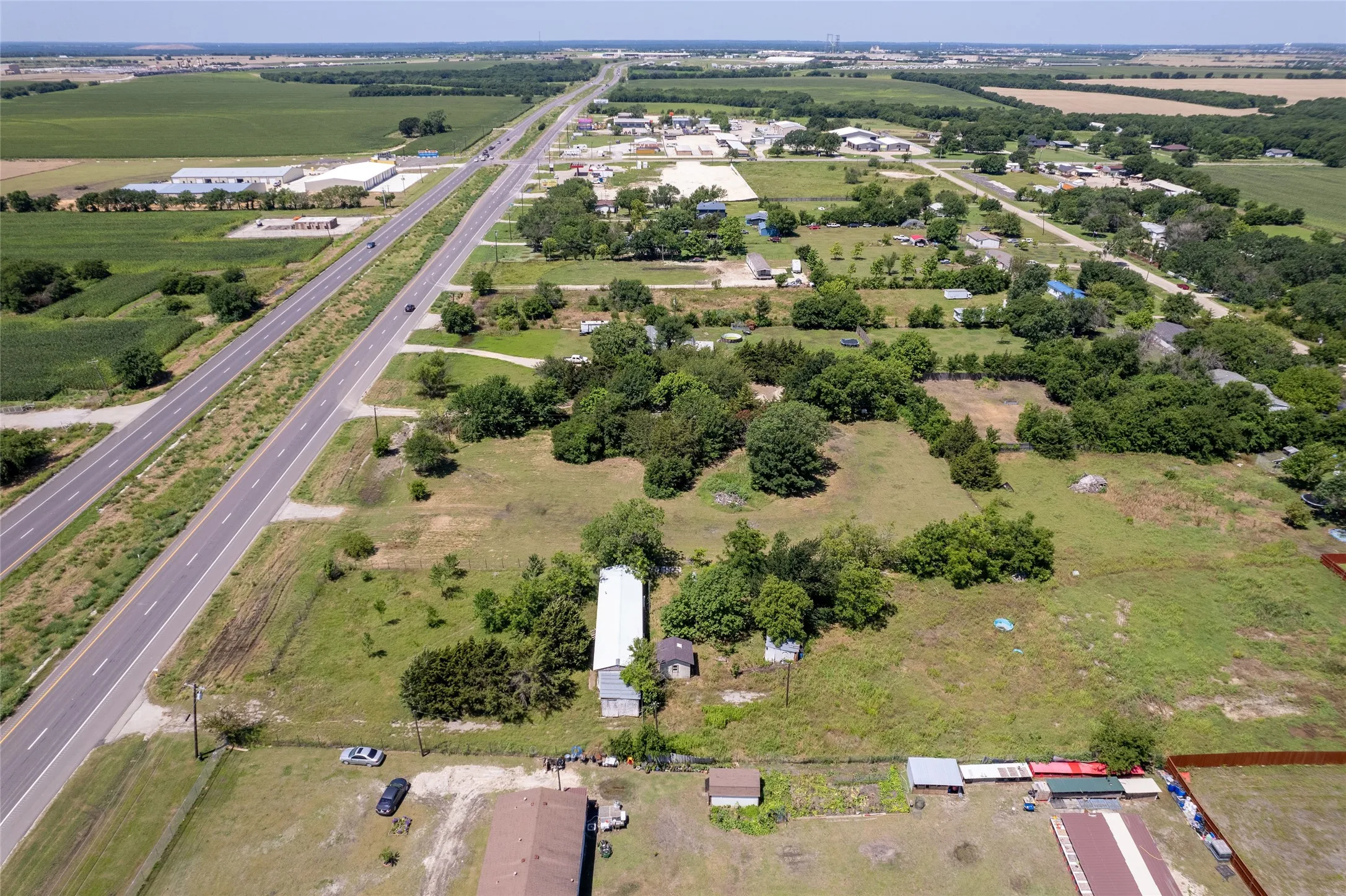 Expansive land parcel featuring open fields and mature trees
