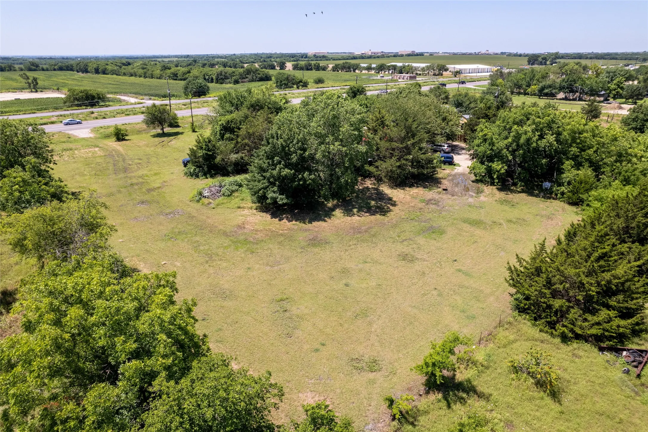 Expansive open land with established trees and natural foliage