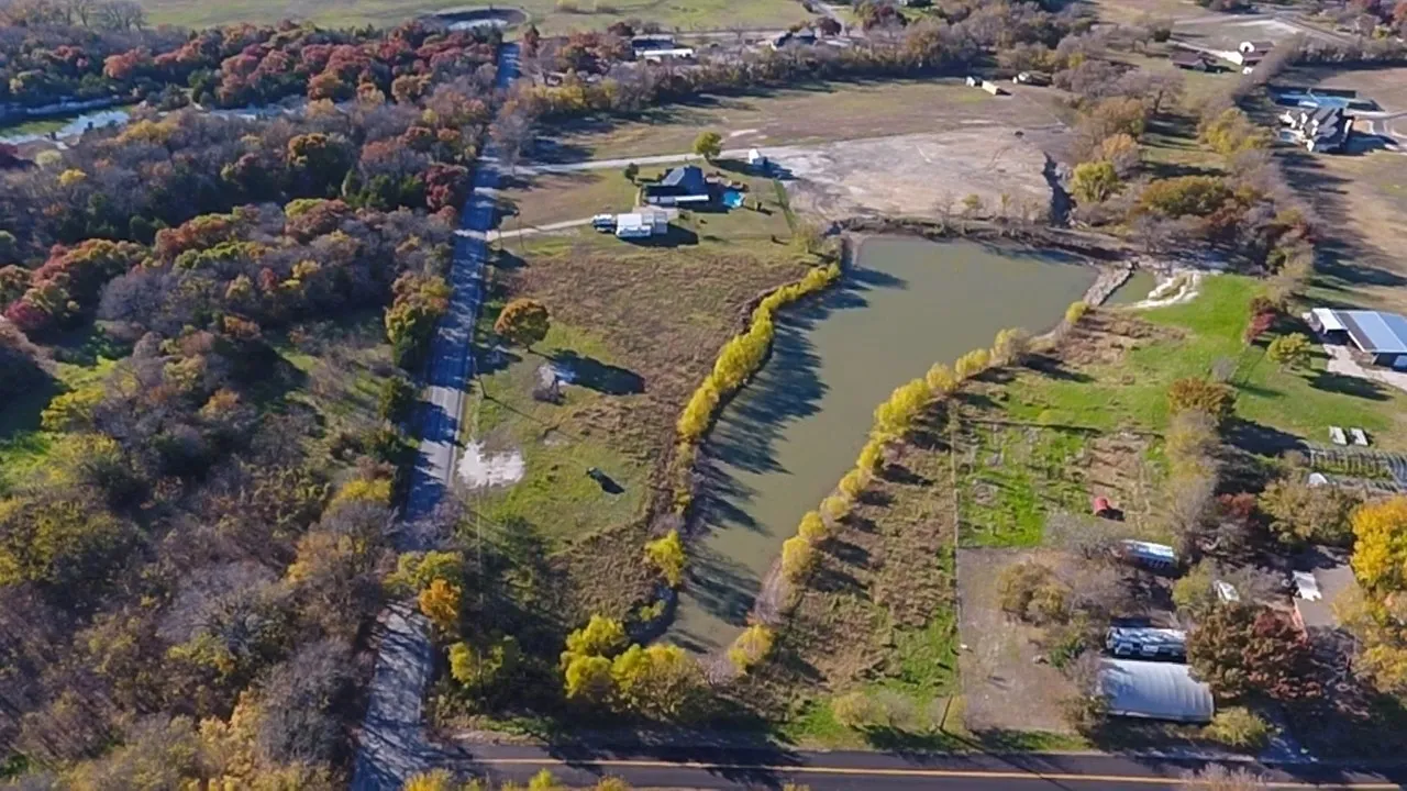 Expansive lot featuring a private pond, clear land, and mature perimeter trees