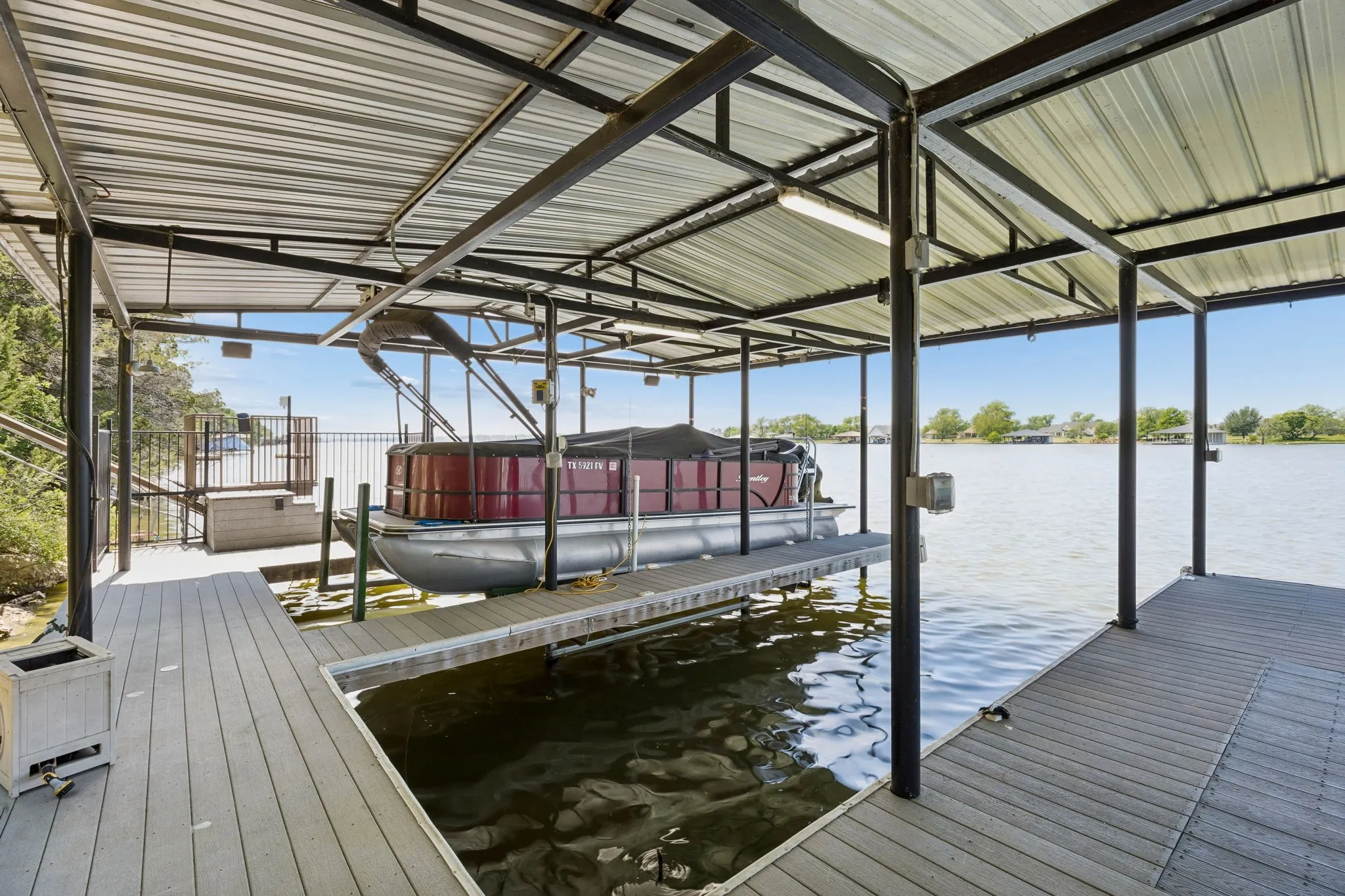 Wide decking and open layout dock create a easy functional setup for lake access or relax time at the water's edge, Custom lift has been designed for wide &b long boat such as a pontoon boat pictured (it is for sale).