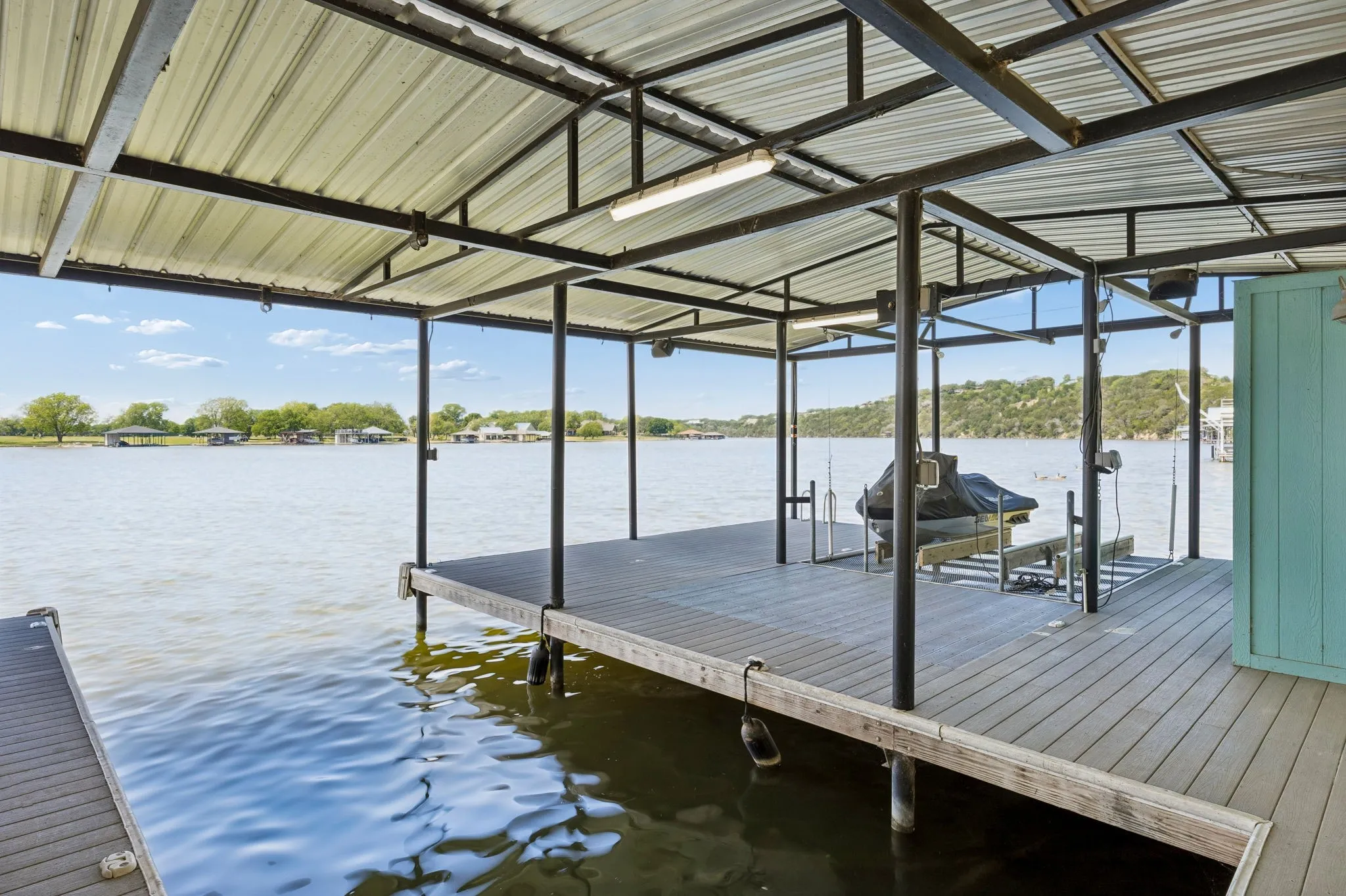 The covered mulkti-slip dock is built with boat lift, additional slip ajnd deidicated space for 2 jet skis.