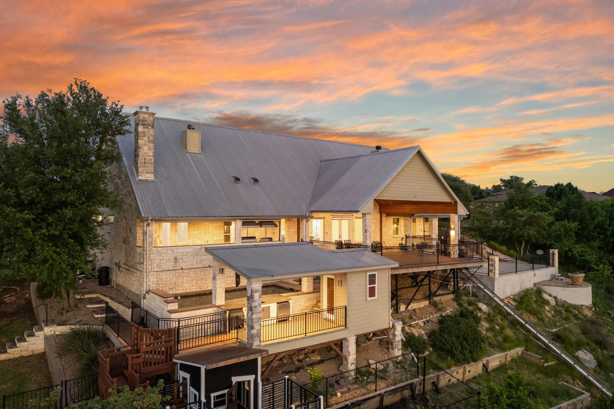 Amazing view of the back of home and tiered decks at twiight