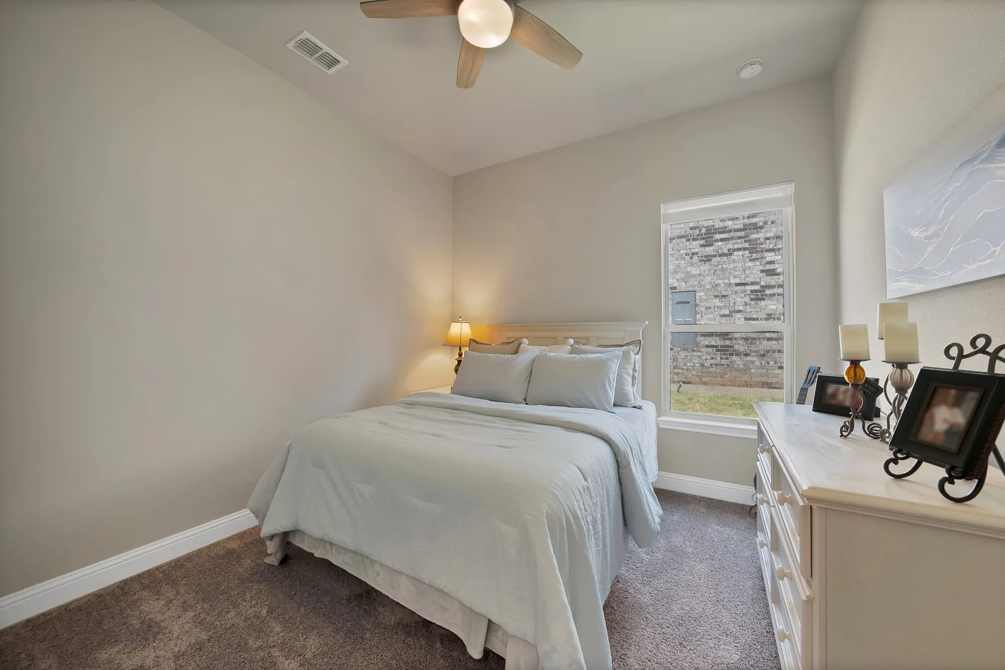 This room features neutral-toned walls, a carpeted floor, and a window providing natural light