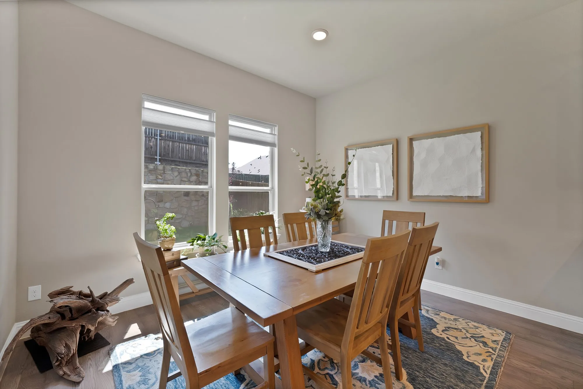 The property offers a dining area with two windows, wood-style flooring, and light-colored walls