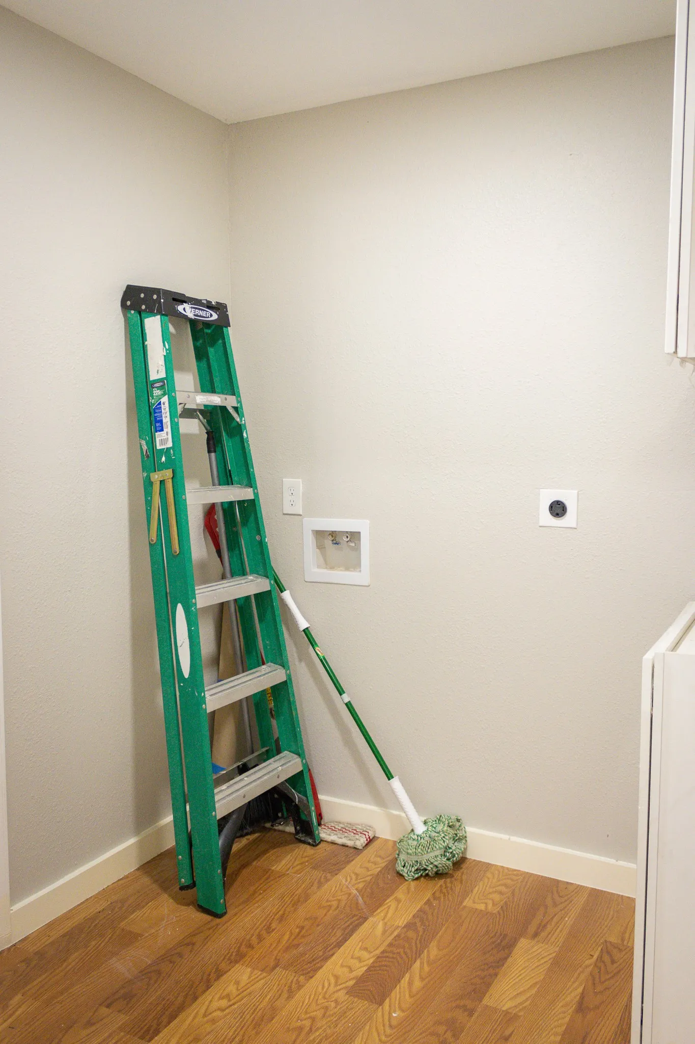 Washroom with electric dryer hookup, wood finished floors, and washer hookup