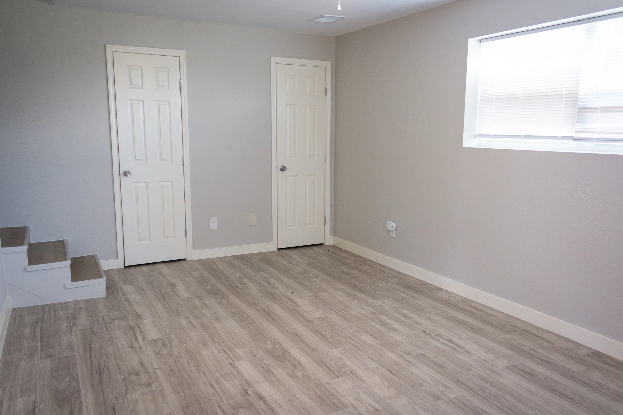 Unfurnished bedroom with light wood-style floors and baseboards