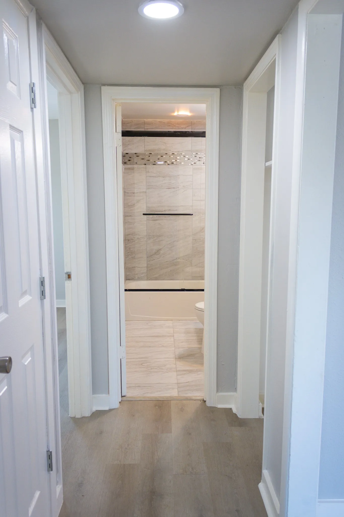 Hall featuring wood finished floors and recessed lighting