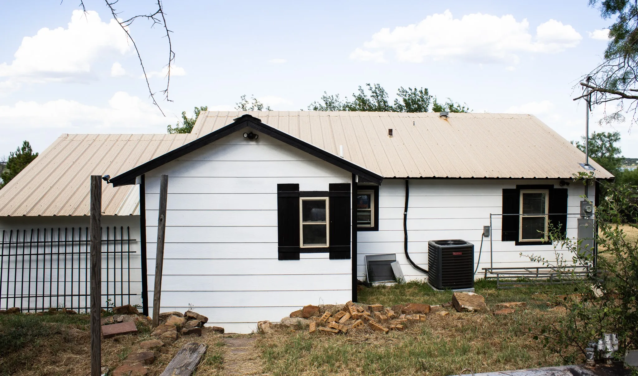 Back of property featuring a metal roof