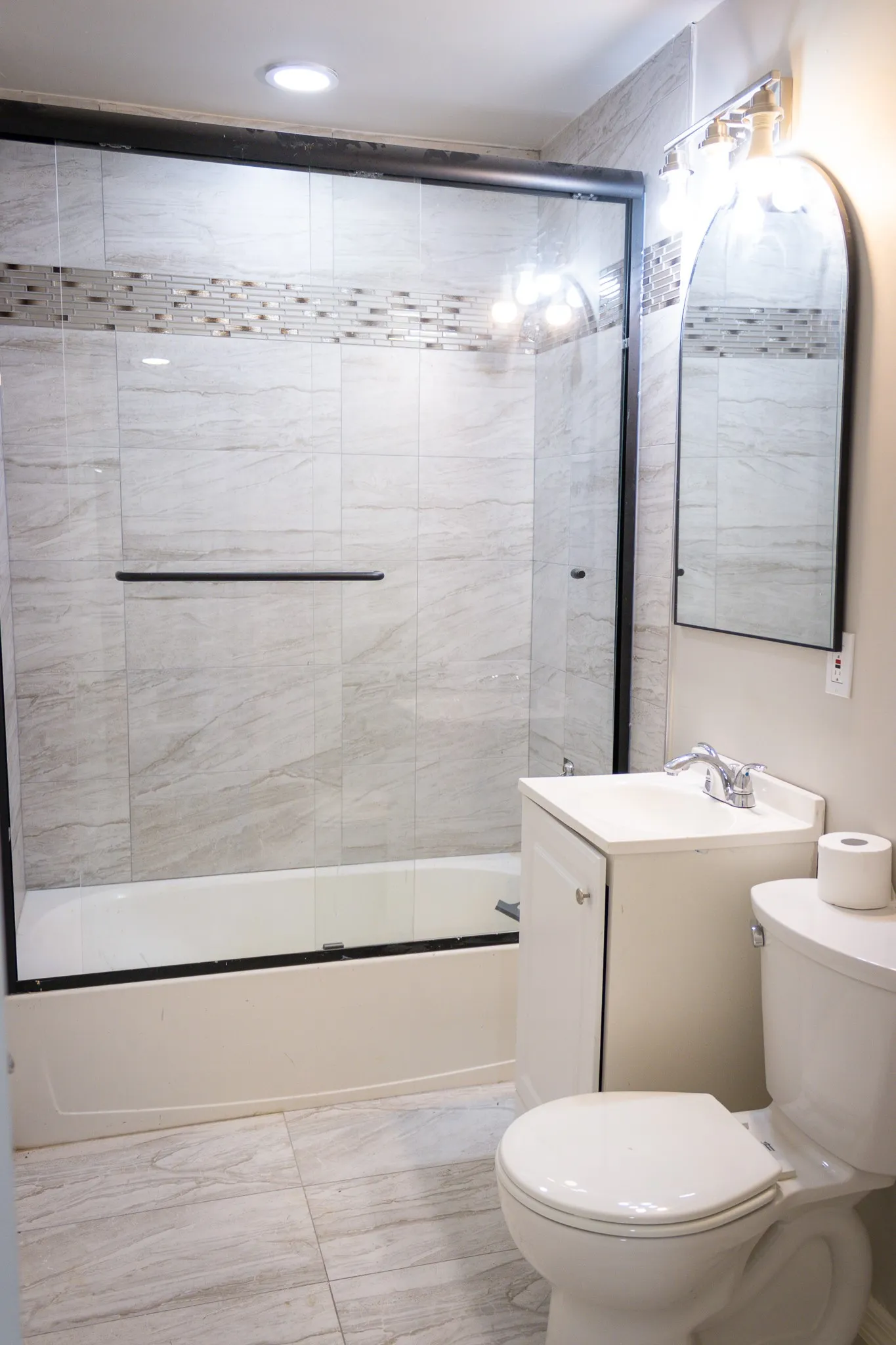 Bathroom featuring enclosed tub / shower combo and vanity