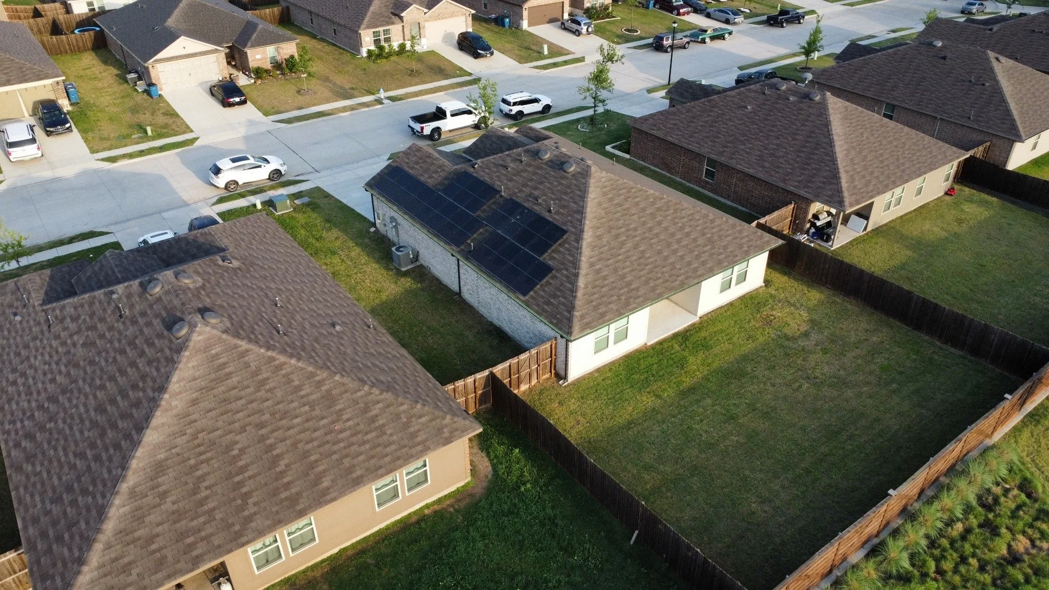 Residential property with a fenced backyard, an exterior patio, and a shingle roof