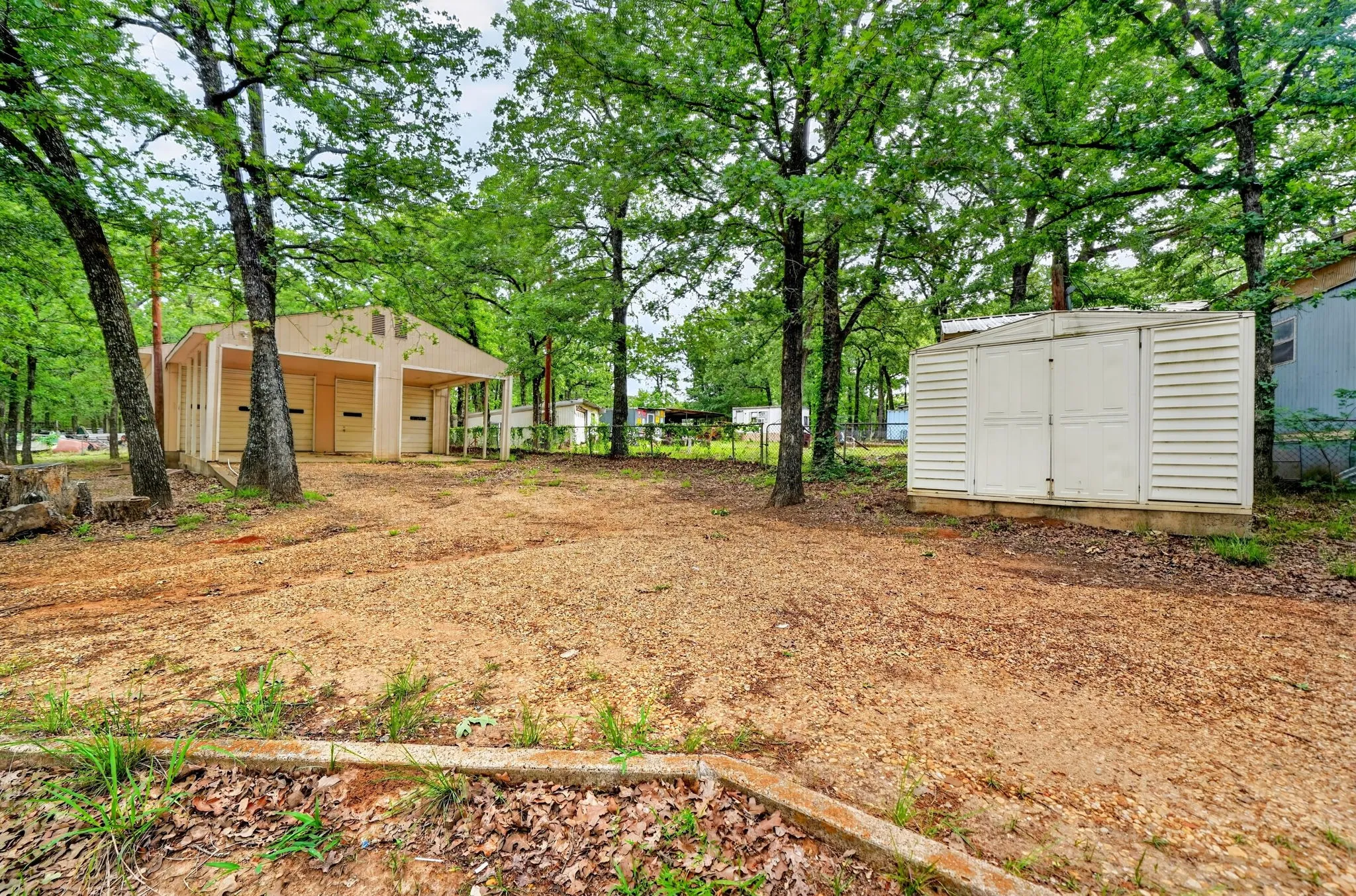 Detached garage structure with two bays and a covered carport area