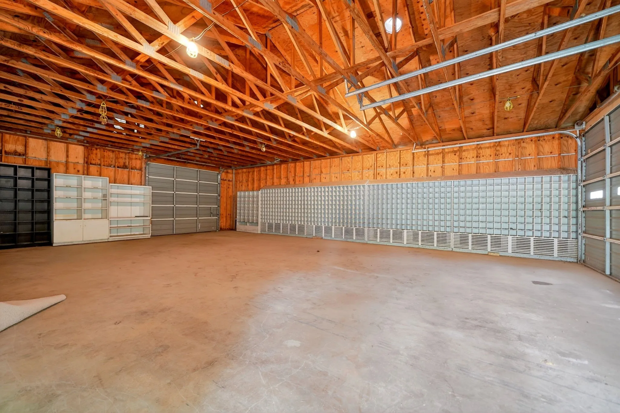 Spacious interior featuring exposed wooden rafters and structural beams