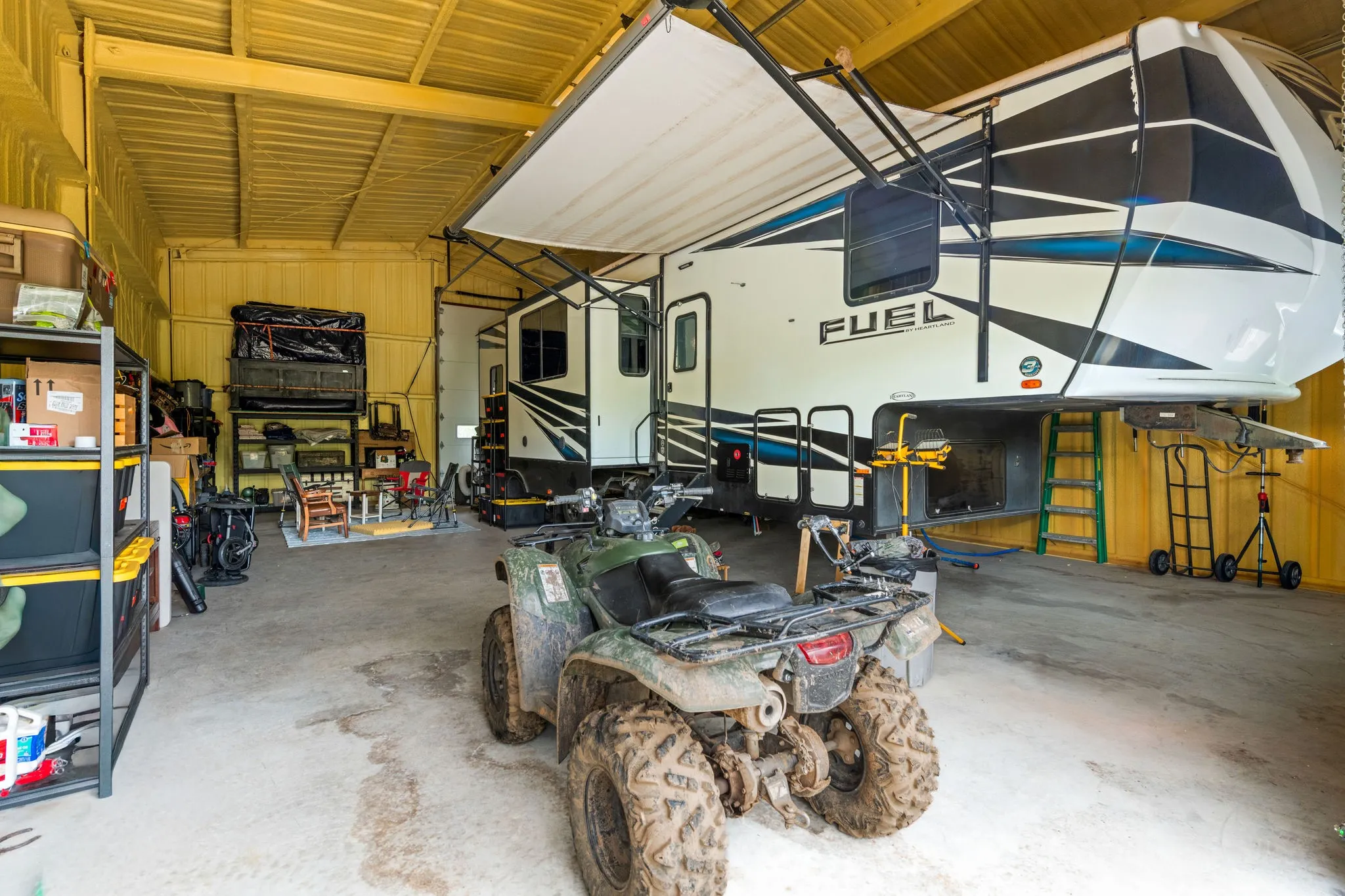 Spacious insulated shop with high ceilings for camper pull thru, durable concrete floor, electric and septic.