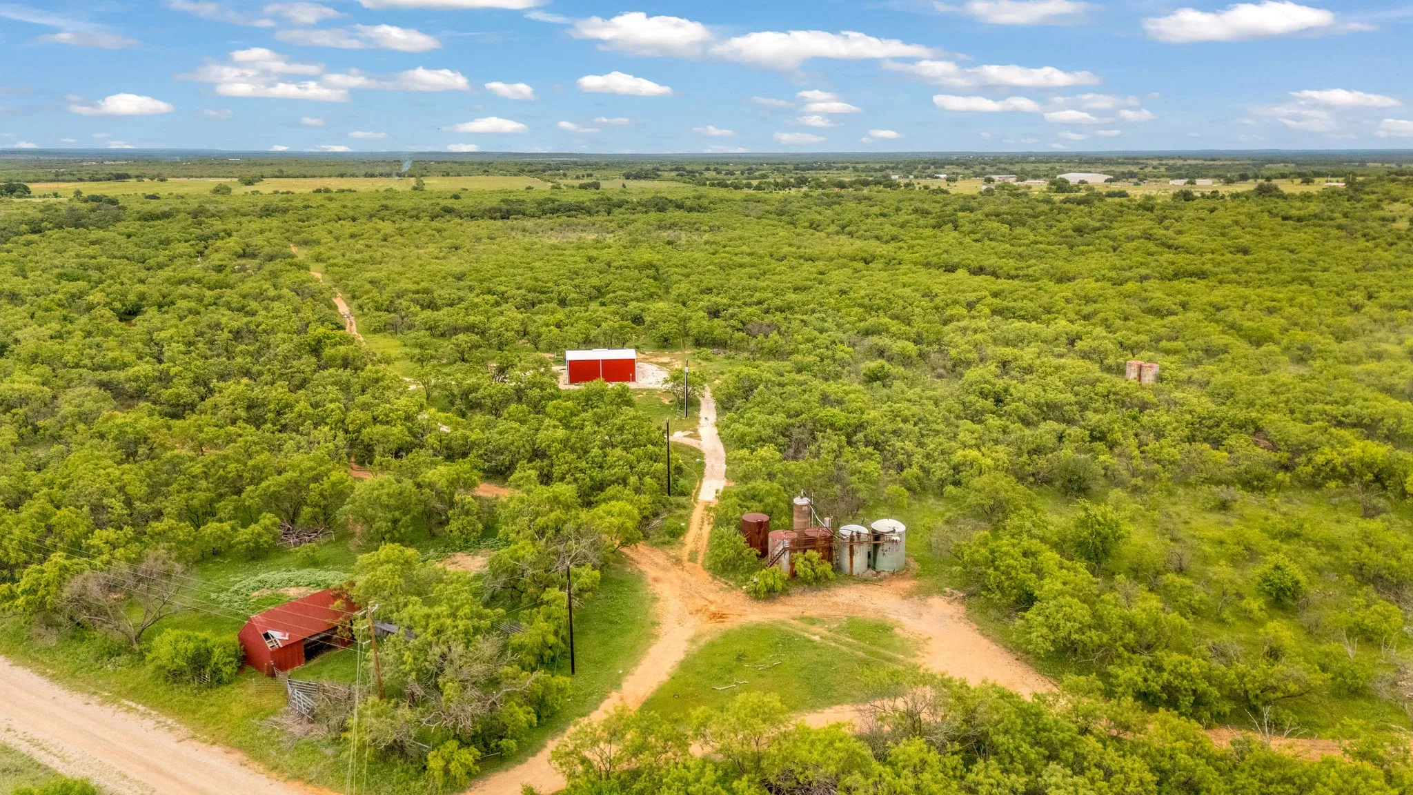 Approximately 80 acres + or - to be determined by survey. Featuring native pasture, outbuildings including a rustic barn and an insulated workshop with electric and septic.
