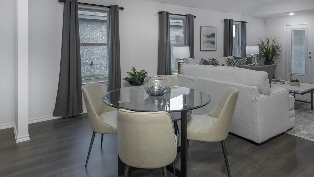 Open-concept living area featuring dark wood-finish flooring, white baseboards, and neutral wall paint