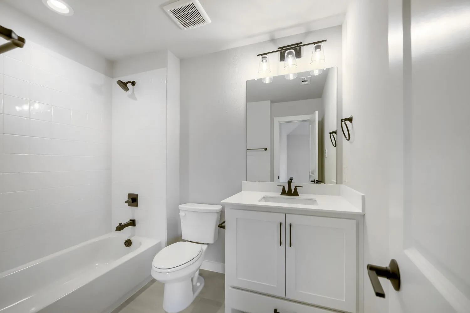 Bathroom featuring a white vanity with a rectangular undermount sink and a light-colored countertop