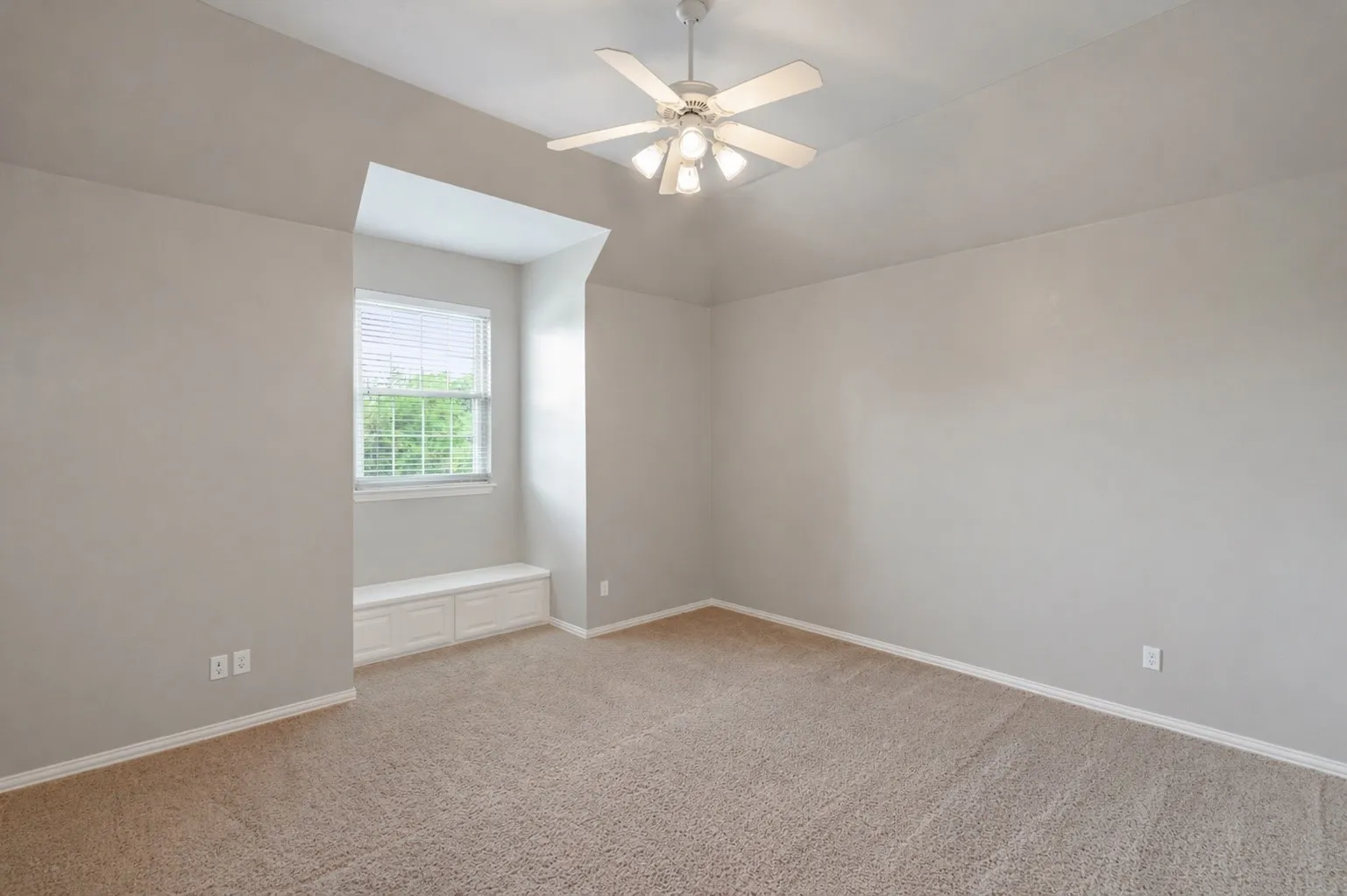 Upstairs bedroom with built in bench and walk in closet.