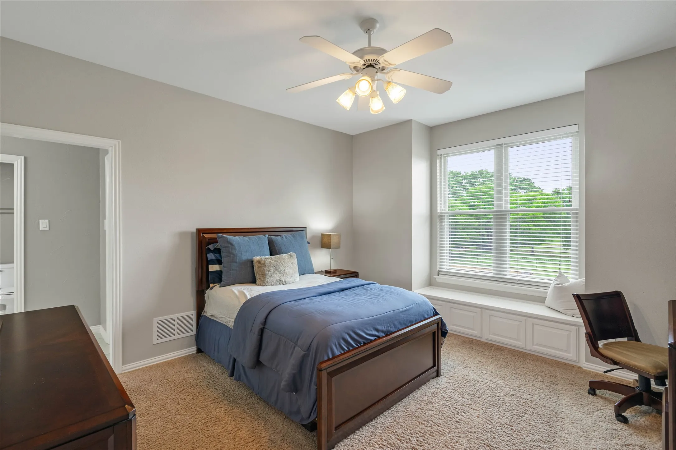 Upstairs bedroom with built in bench and walk in closet.
