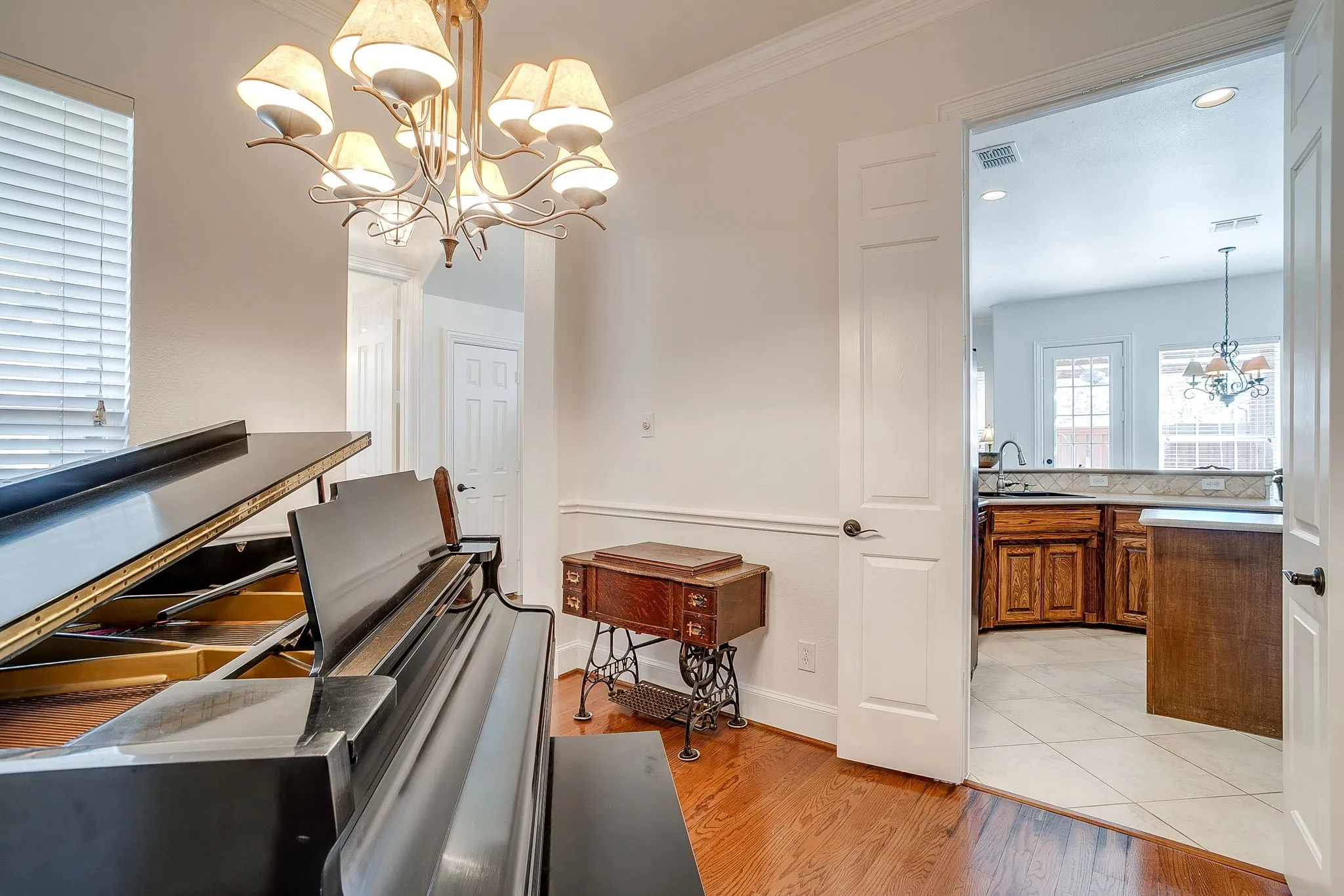 Dining room with a chandelier, light wood-style floors, and crown molding