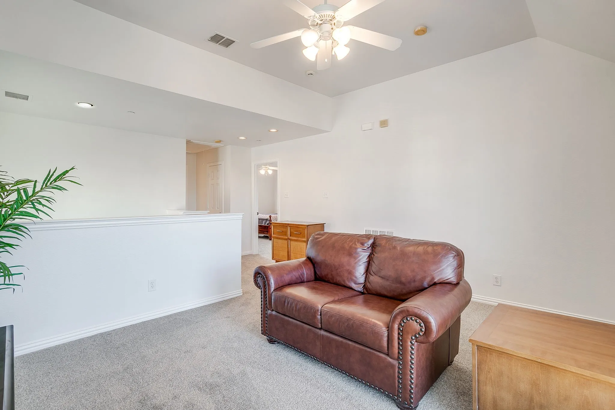 Living room featuring carpet flooring and a ceiling fan