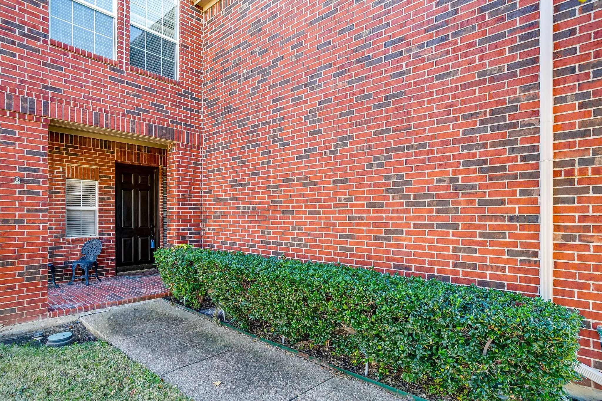 View of exterior entry with brick siding