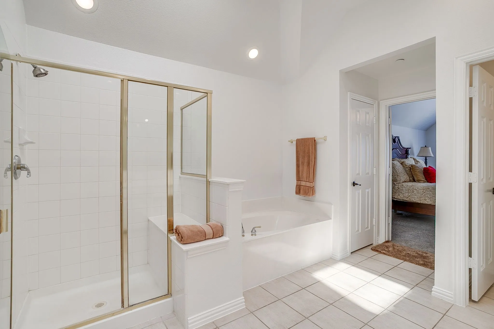 Full bath with connected bathroom, a garden tub, and a shower stall
