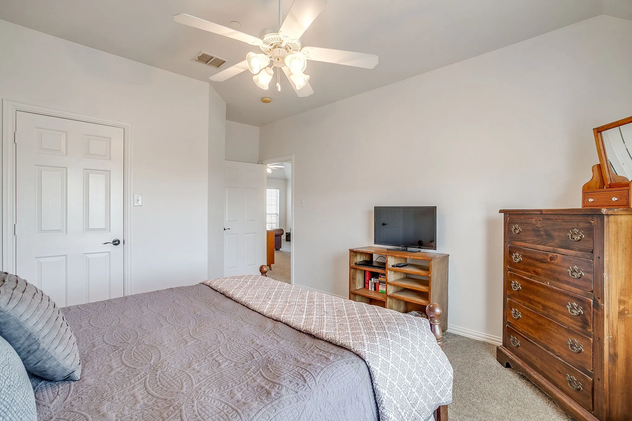Bedroom featuring light carpet, a ceiling fan, and lofted ceiling