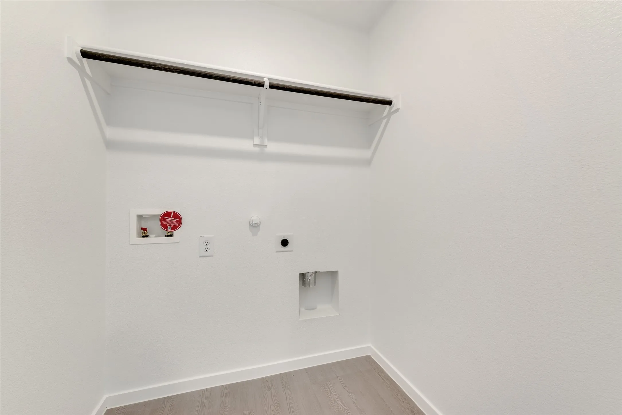 Washroom with gas dryer hookup, light wood finished floors, hookup for a washing machine, and electric dryer hookup