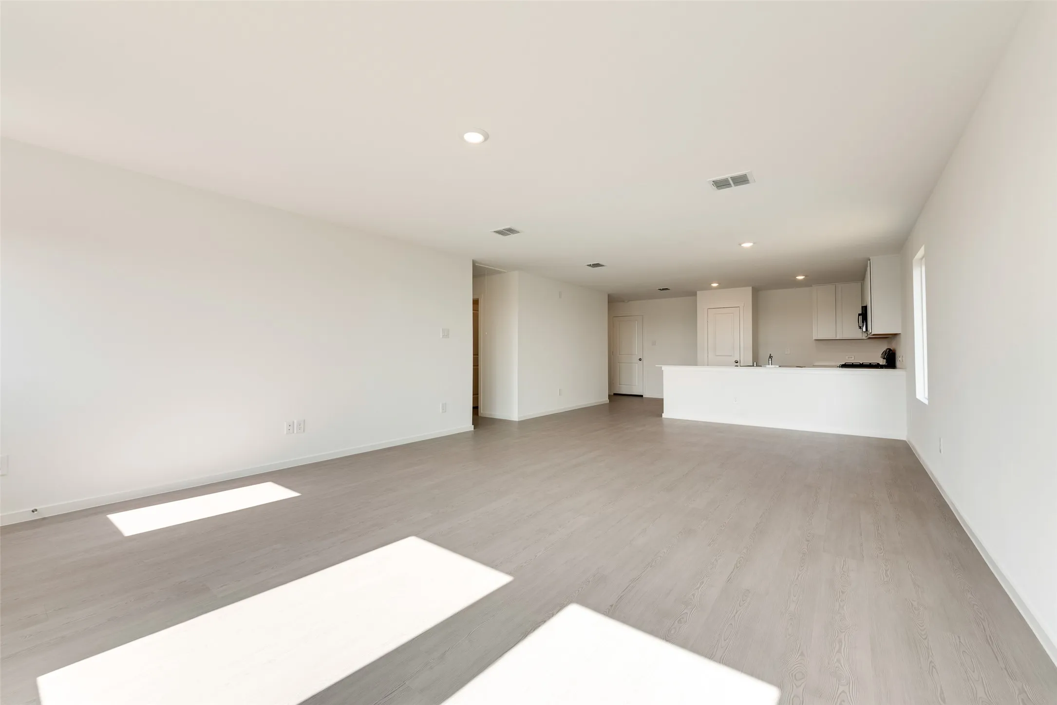 Unfurnished living room with recessed lighting and light wood-type flooring