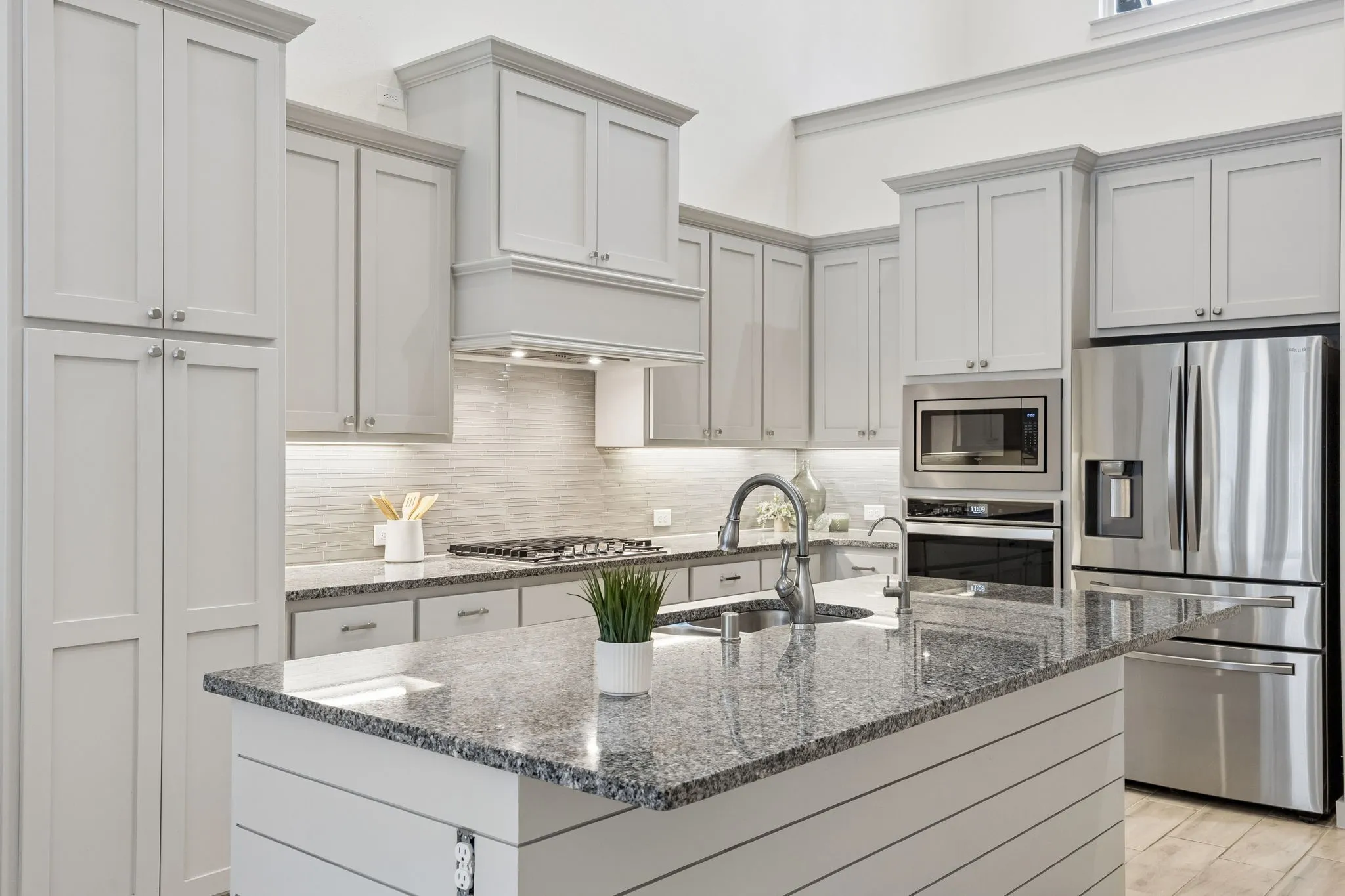 Kitchen has island seating for 4, abundance of cabinets for storage.