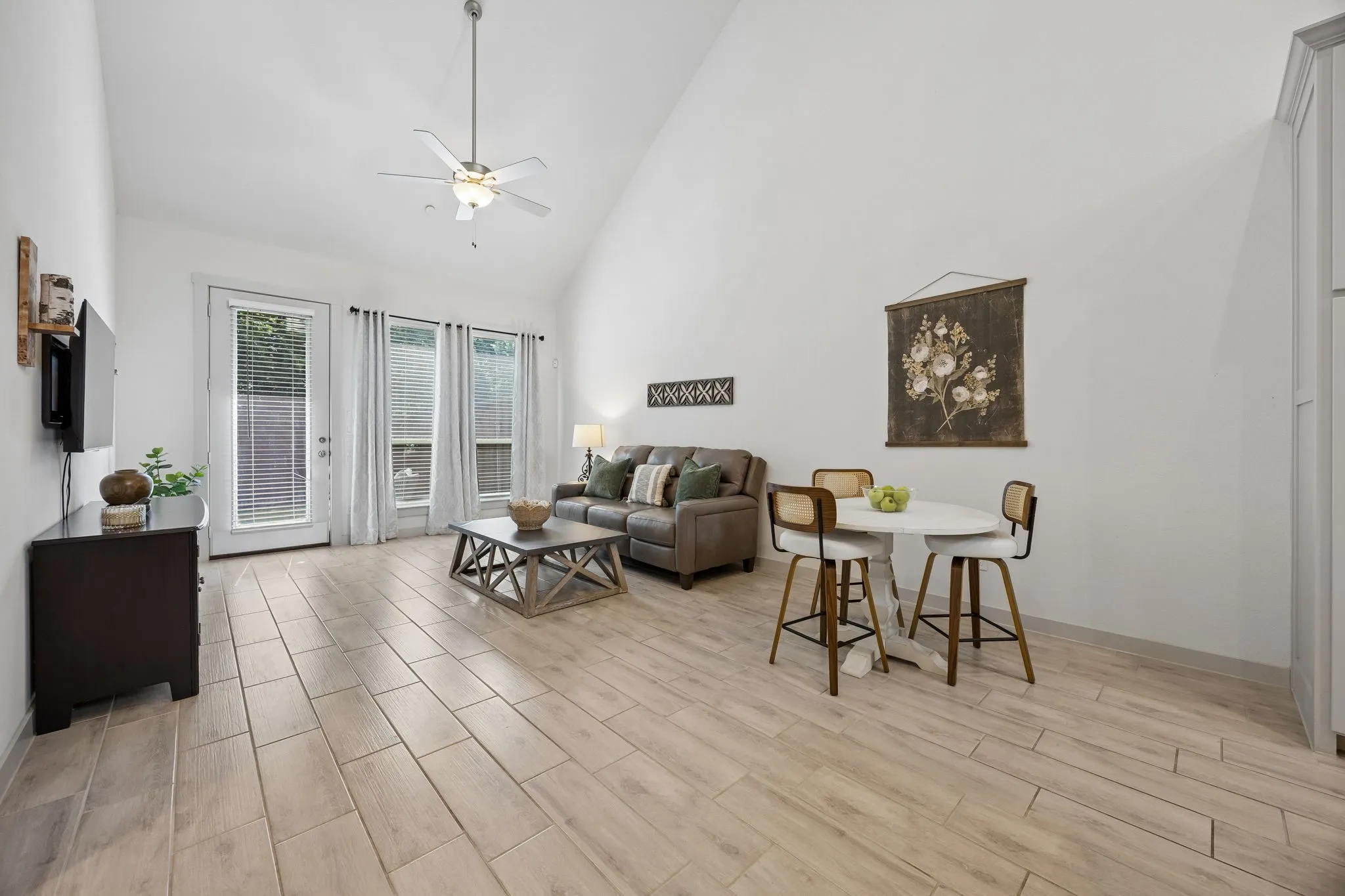 Living area creates a warm and inviting atmosphere for relaxing evenings. High ceilings continue opening up the space.