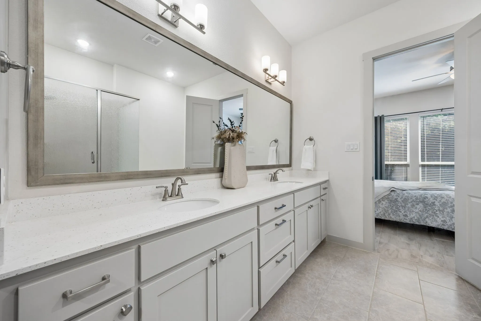 The primary ensuite has a large double vanity with multiple drawers and cabinets for all you storage needs.