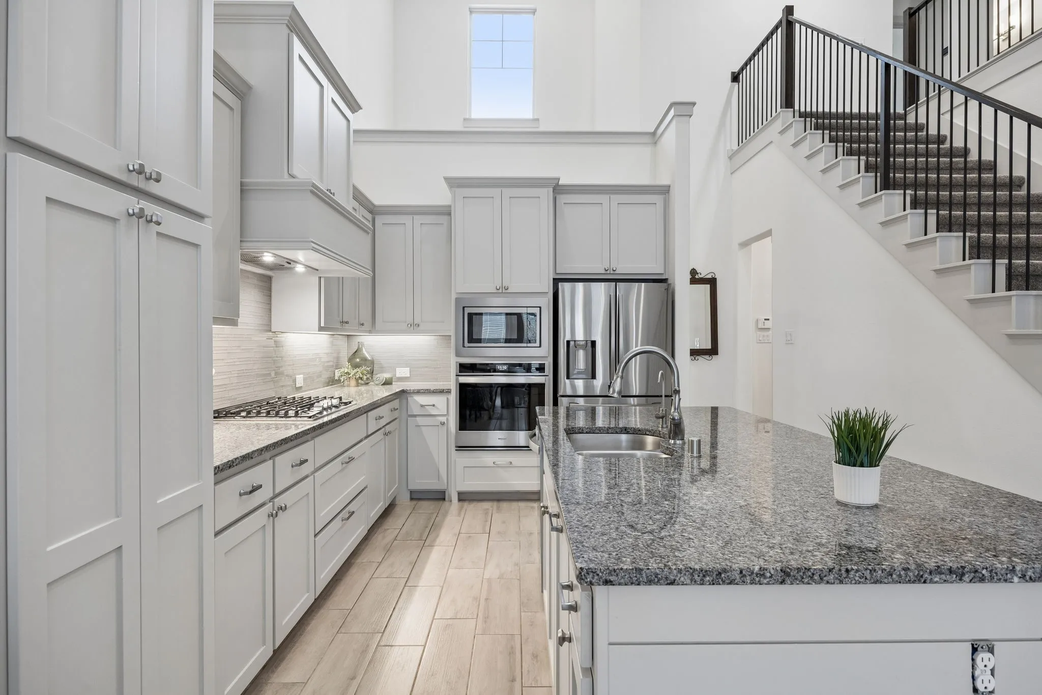 The gourmet kitchen is a chef’s dream, with sleek granite countertops, stainless steel appliances, and an oversized island that’s perfect for casual breakfasts or entertaining guests