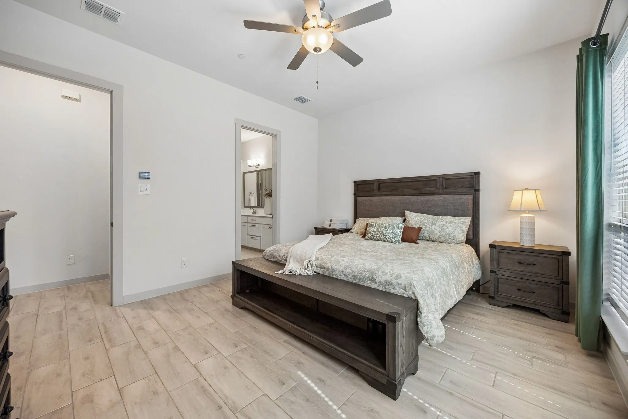 Primary suite is well sized and roomy with large windows overlooking yard and  greenbelt.