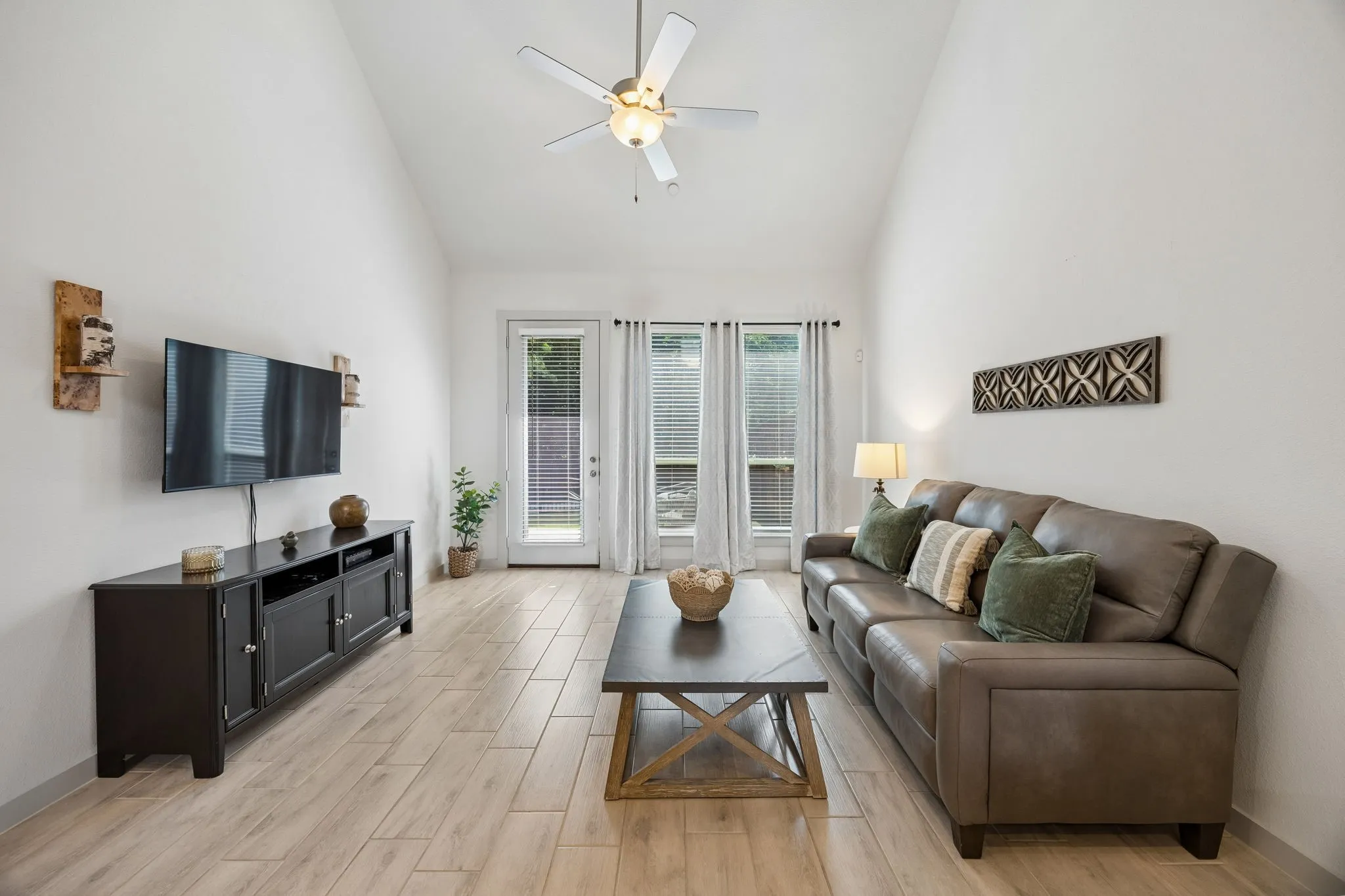 Large windows bathe the interiors in natural light, while the home’s neutral palette and tasteful finishes provide a timeless canvas ready to complement any style.