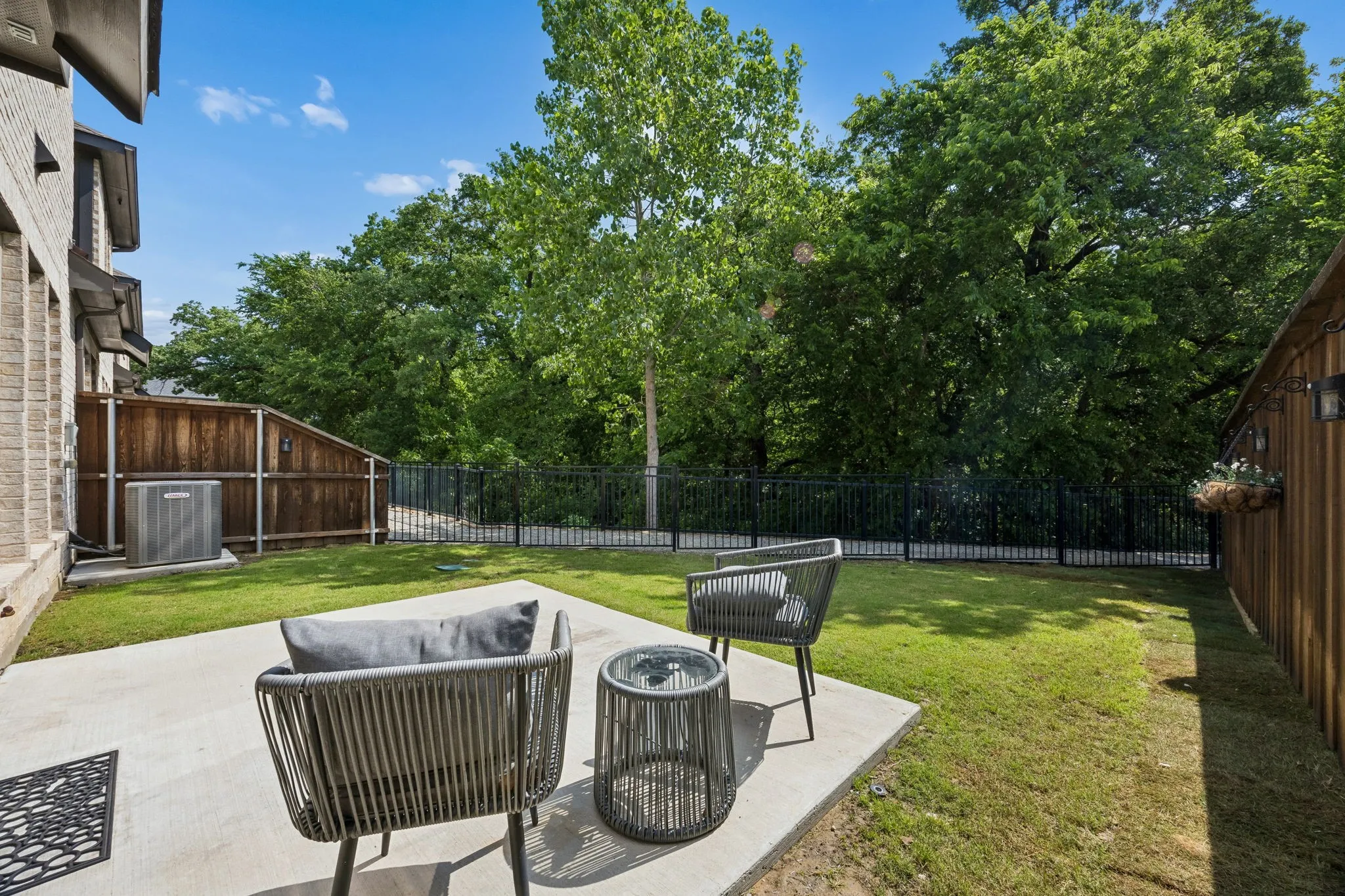 The backyard patio is ideal for al fresco dining and plenty of room for play, gardening, or simply soaking in the greenbelt view and serene surroundings.