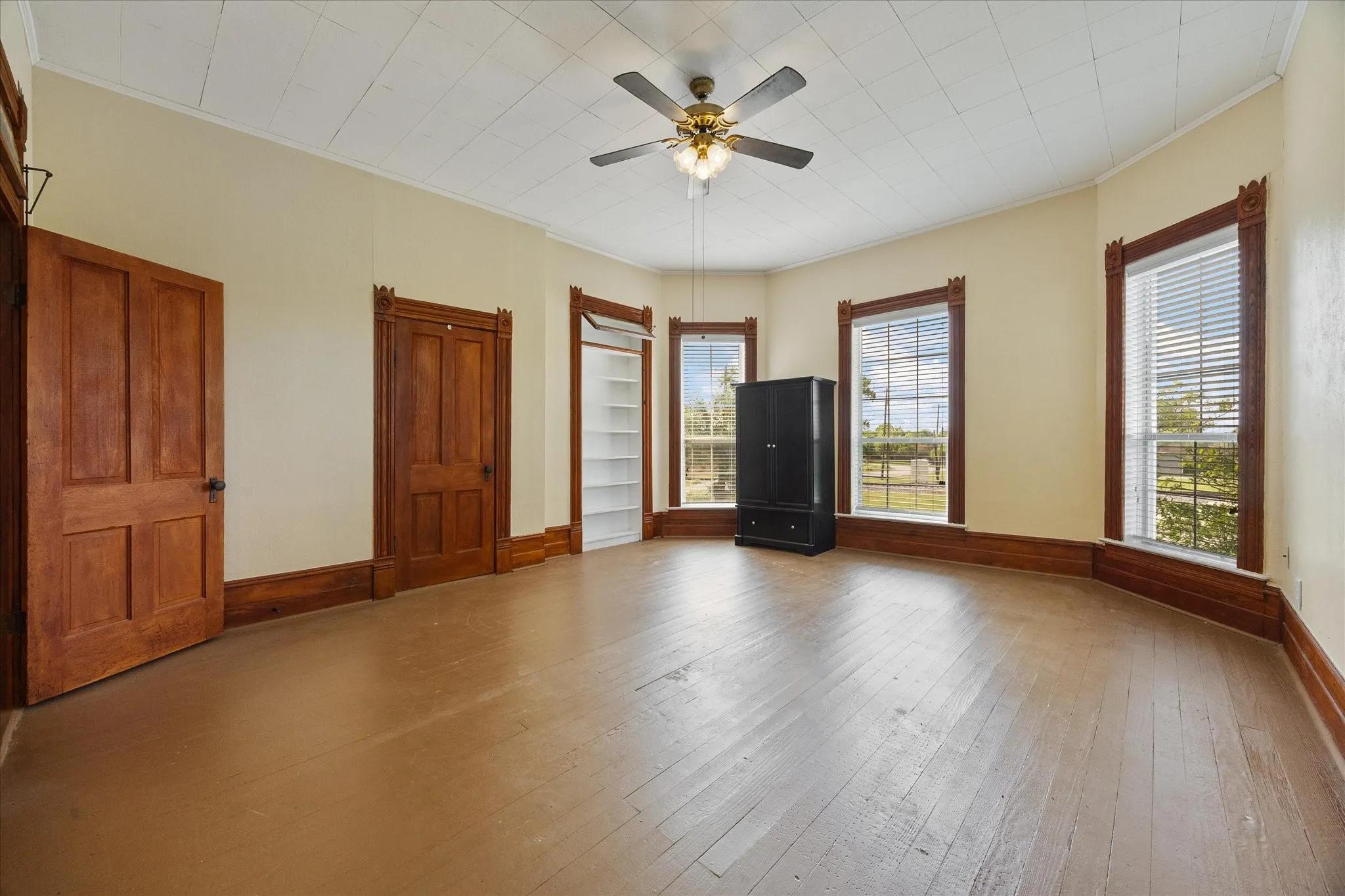 Spacious room featuring wood-finish flooring and a neutral color palette