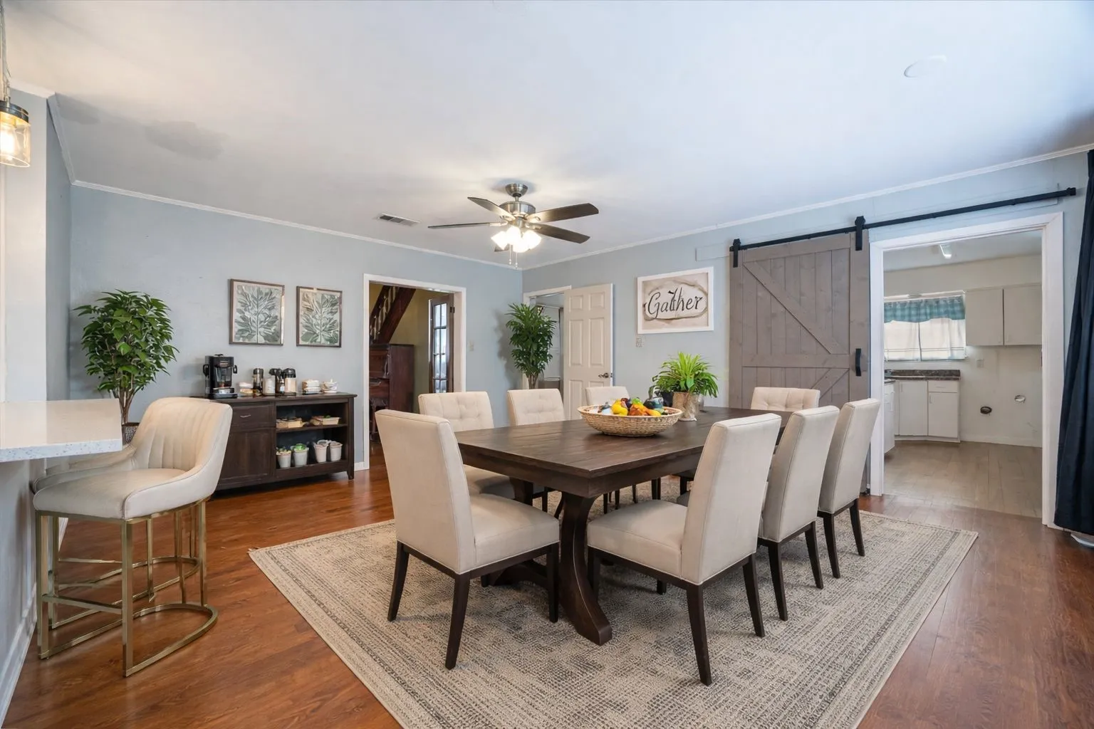 Open concept dining area featuring wood-finish flooring and a ceiling fan