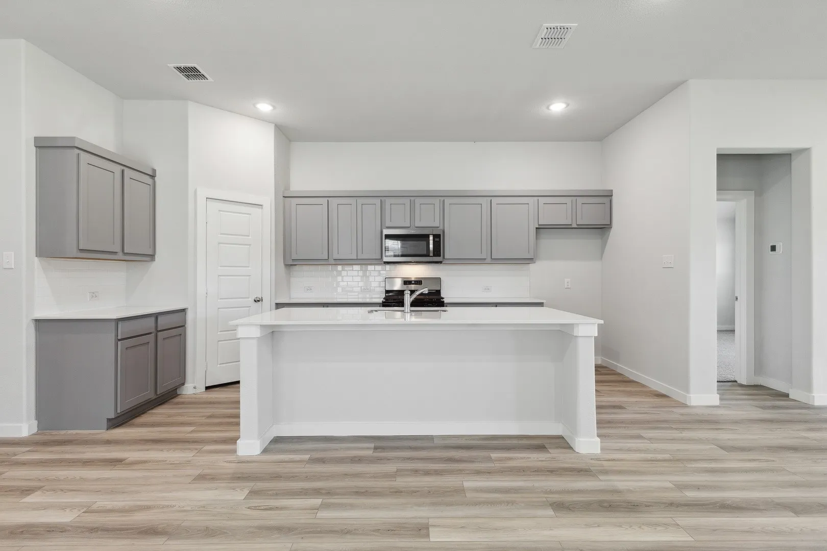 Kitchen in the Quartz home plan by Trophy Signature Homes – REPRESENTATIVE PHOTO