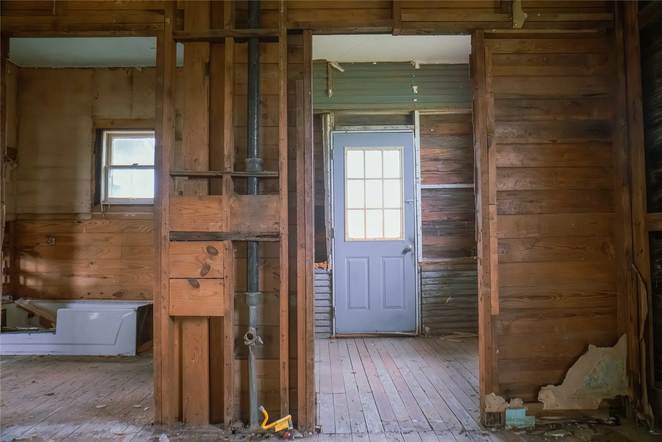 Interior framing and wall studs with visible plumbing lines