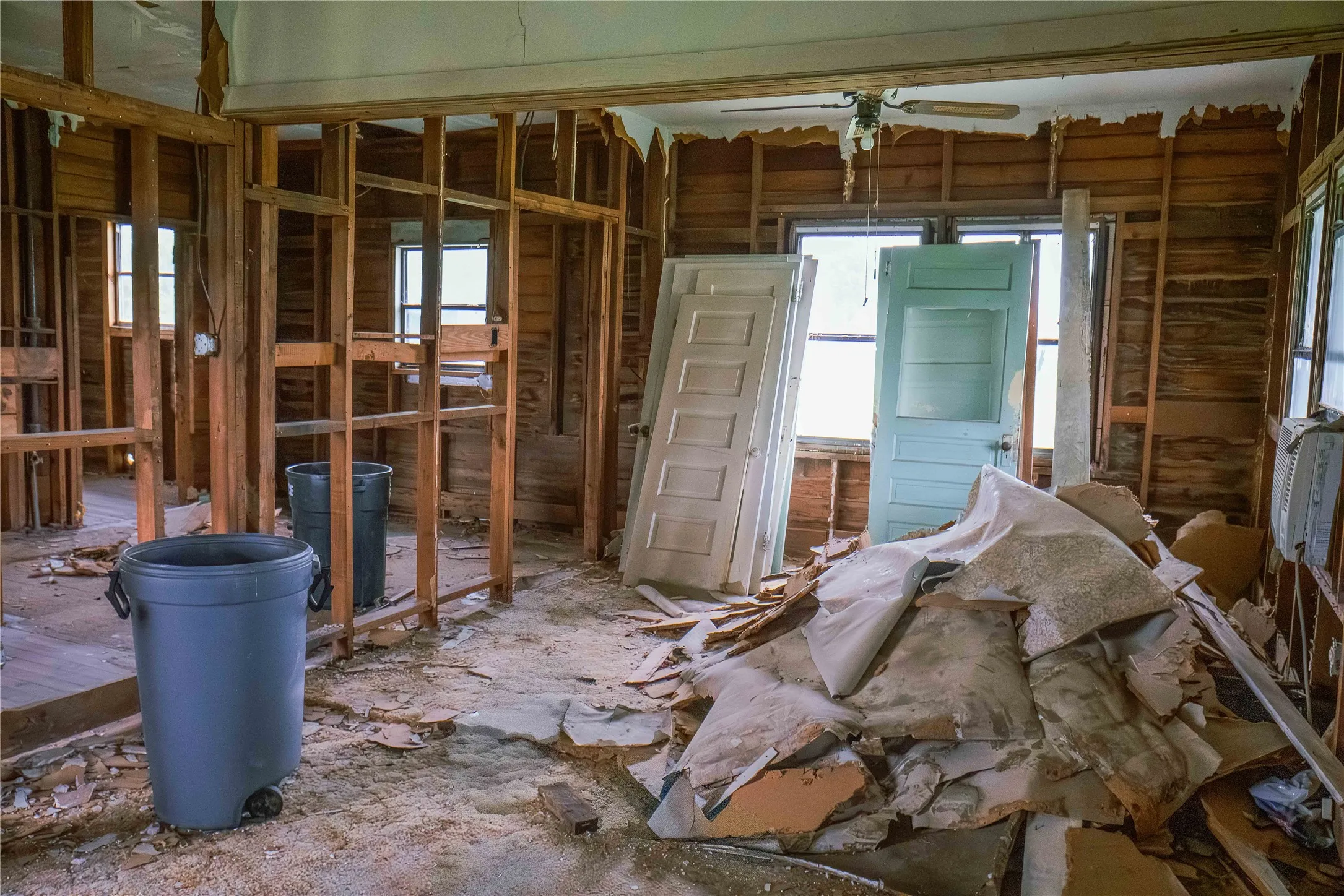 Interior space featuring exposed wood wall framing and ceiling joists