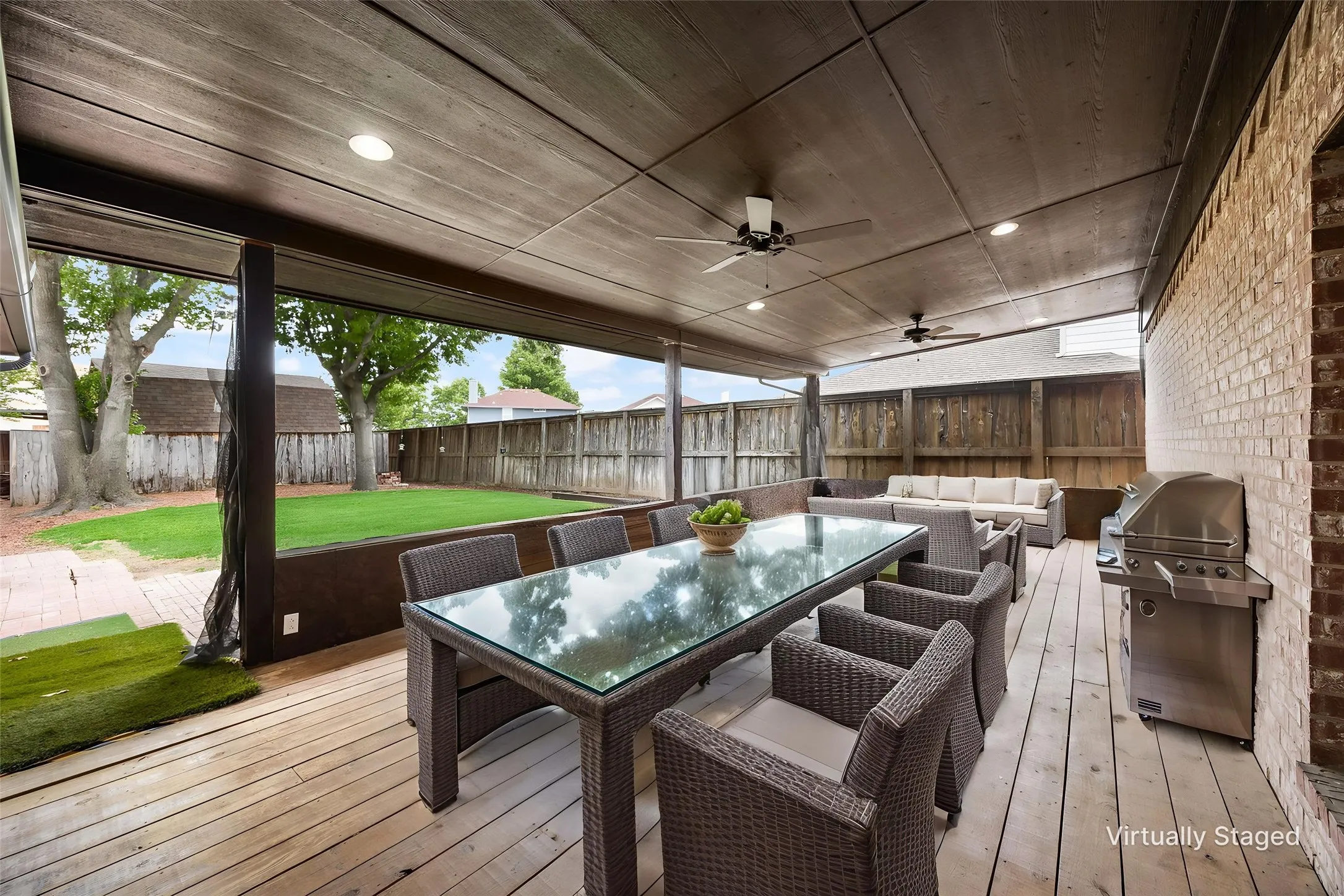 Large deck with two ceiling fans and room for lots of outdoor furniture