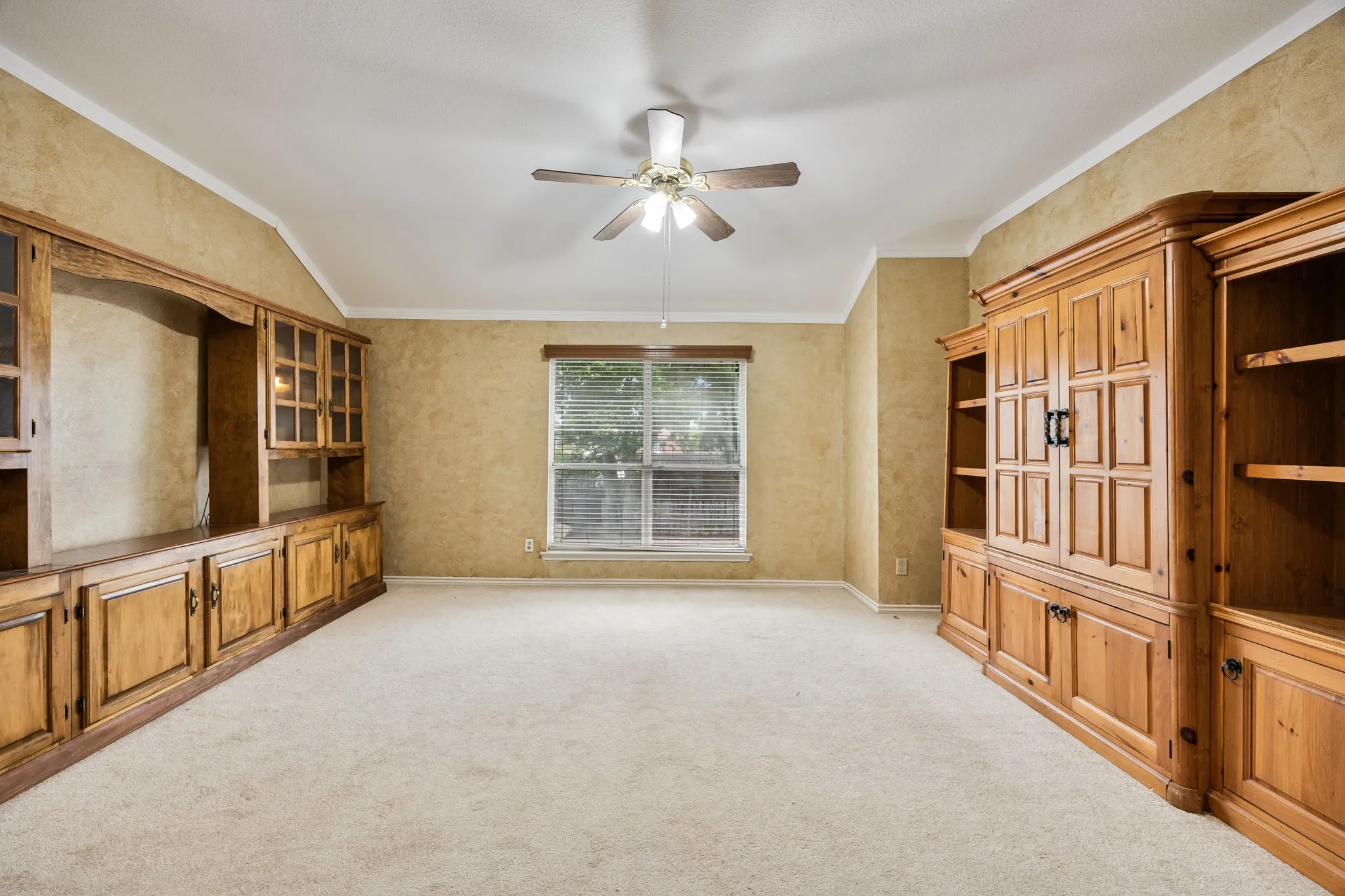 2nd floor living area with TV cabinet and storage or display cabinets.