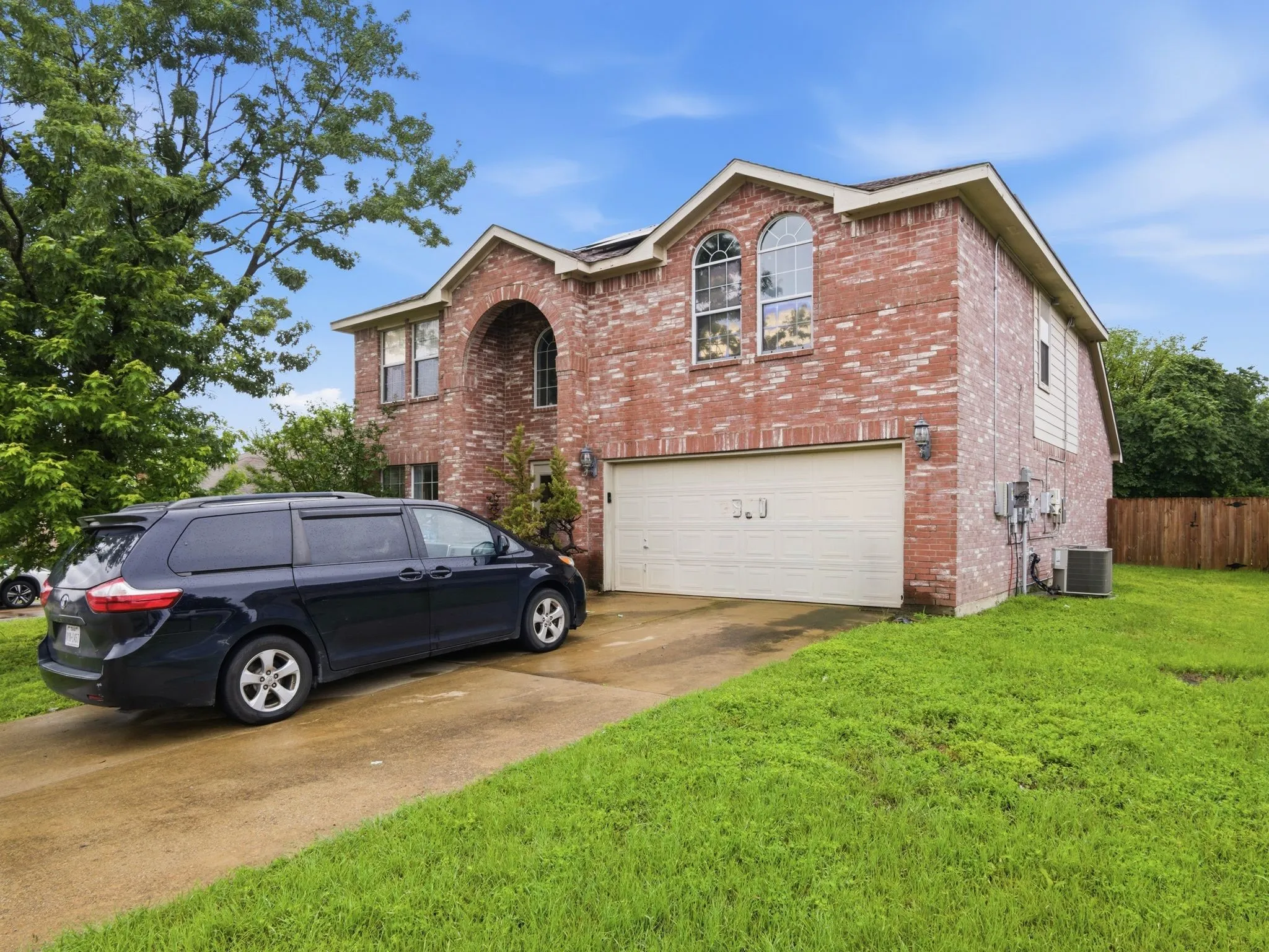 Brick veneer exterior featuring an arched entry