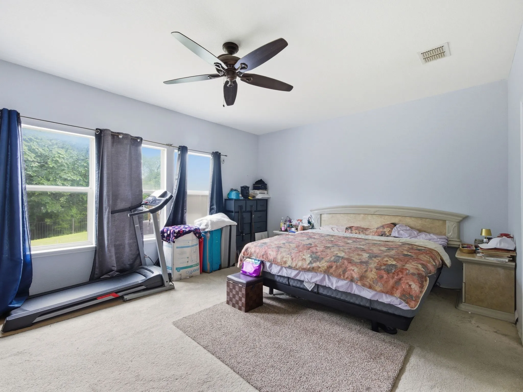 Bedroom featuring light-colored carpeting and a ceiling fan