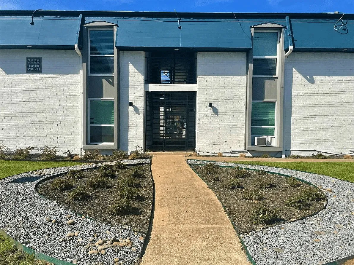 White brick exterior with a blue roofline