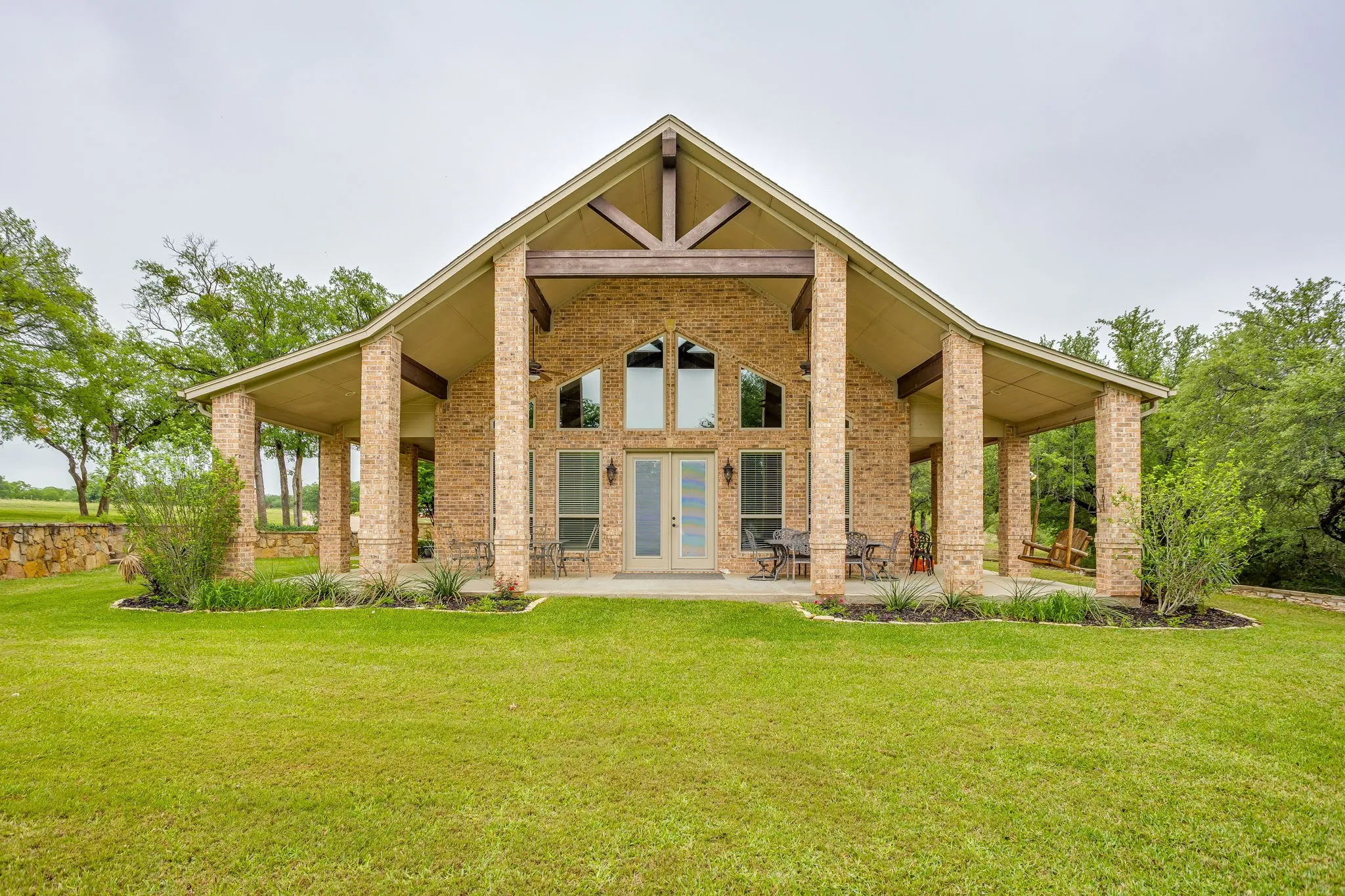Brick exterior with a prominent A-frame architectural style and exposed timber beams