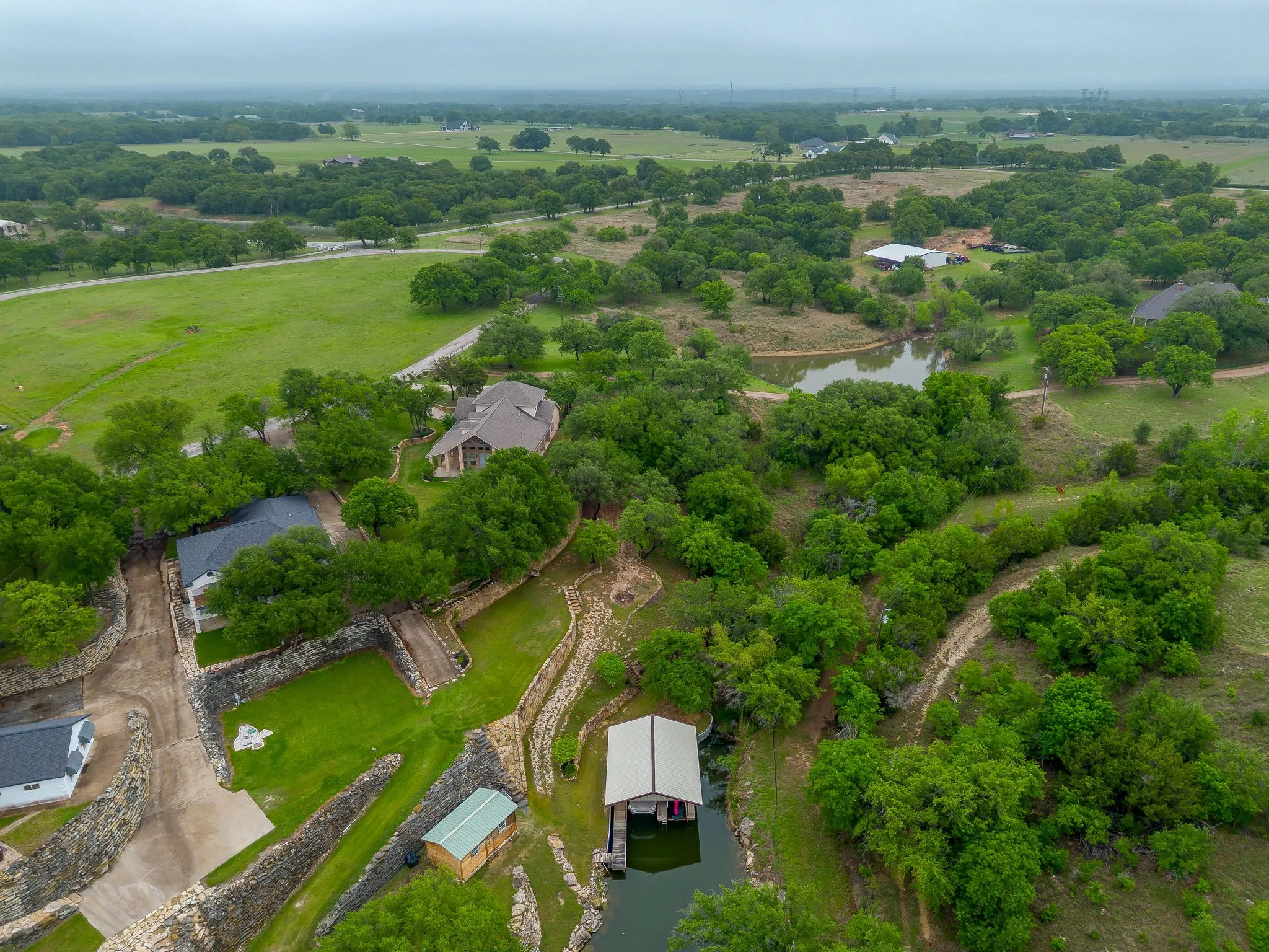 Expansive property featuring a boat dock, private pond, and extensive green space