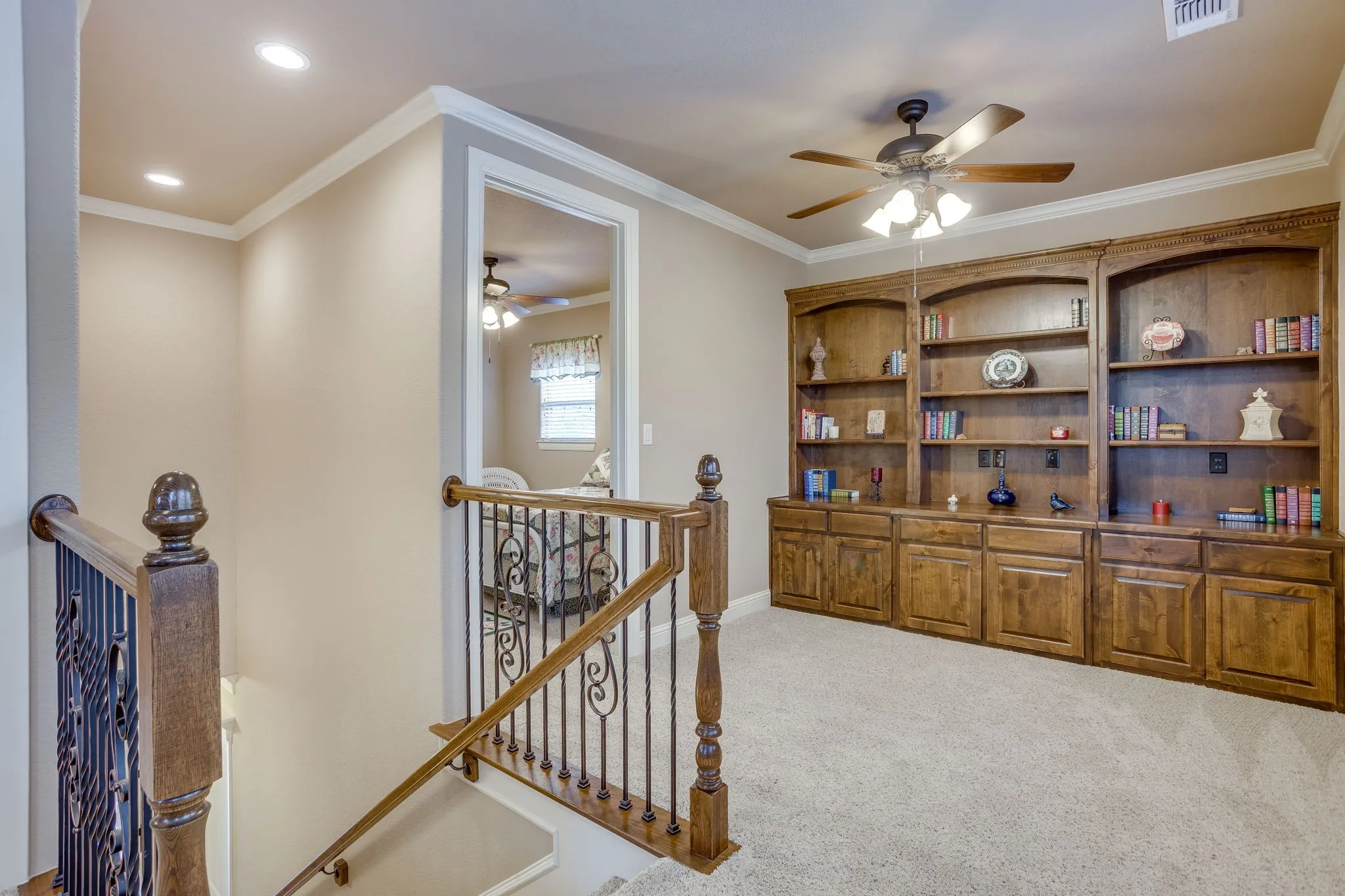 Built-in wood shelving and cabinetry with crown molding details