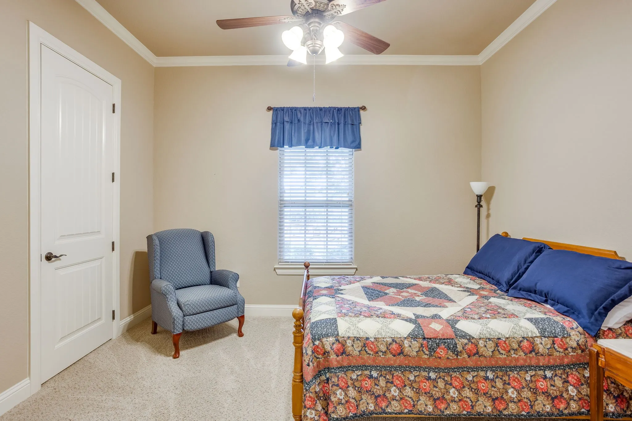 Bedroom featuring neutral wall color, crown molding, white trim, and carpet flooring